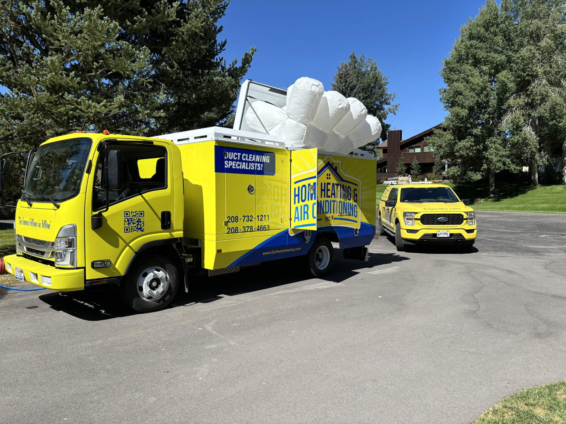 Home Heating & Air Conditioning arrives in bright, professional trucks to provide trusted duct cleaning and dependable service to homeowners.
