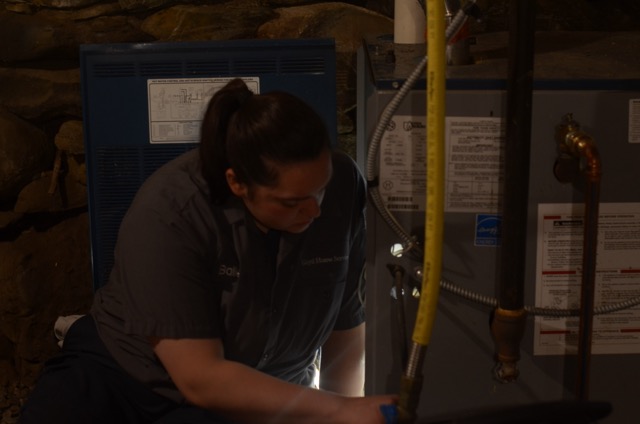 Trust Lloyd Plumbing, Heating, Air, Electrical for dependable in-home HVAC care, showing skilled technicians focused on safe, precise repairs.