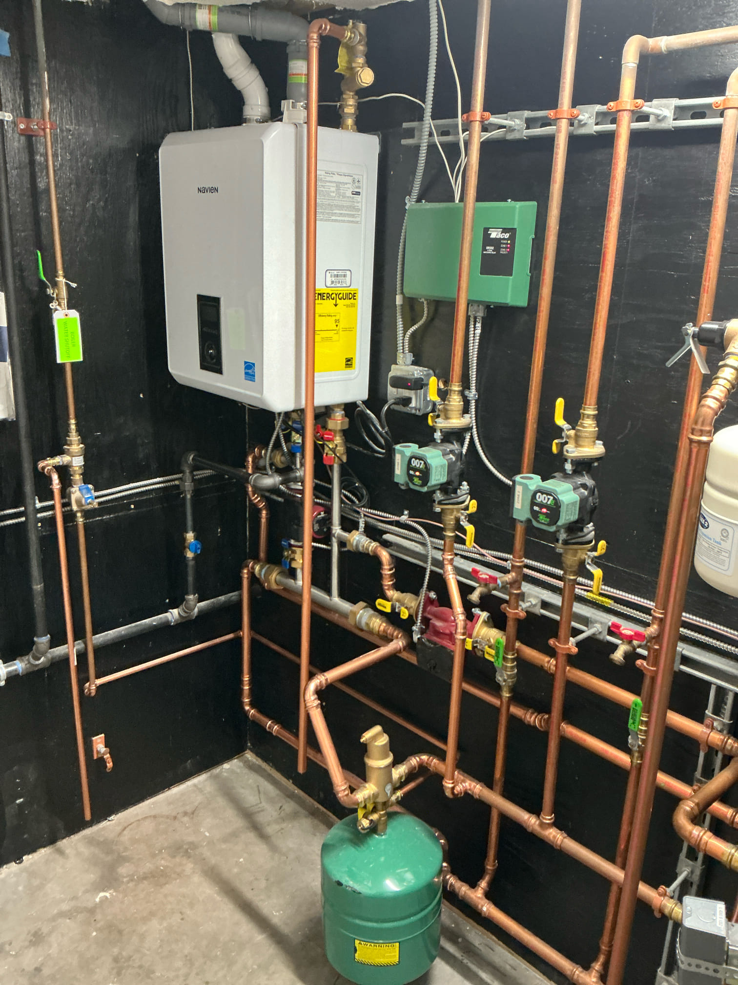Akian Plumbing, Heating, Cooling & Electric showcases its expertise with a precisely installed tankless water heater system, reflecting a commitment to excellence and modern efficiency.
