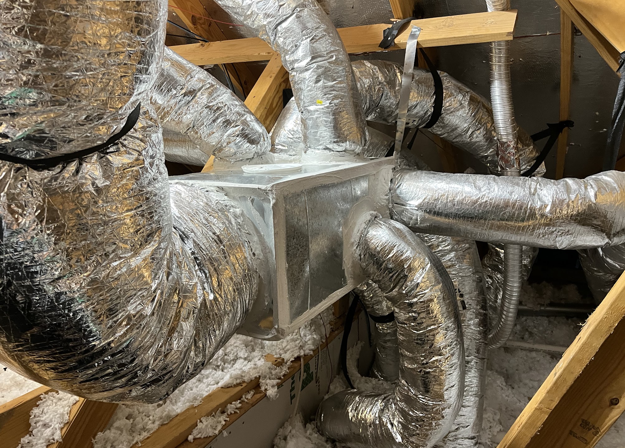 Careful, professional ductwork and sealing in the attic shows how Abacus Plumbing, Air Conditioning & Electrical delivers efficient, lasting HVAC performance.