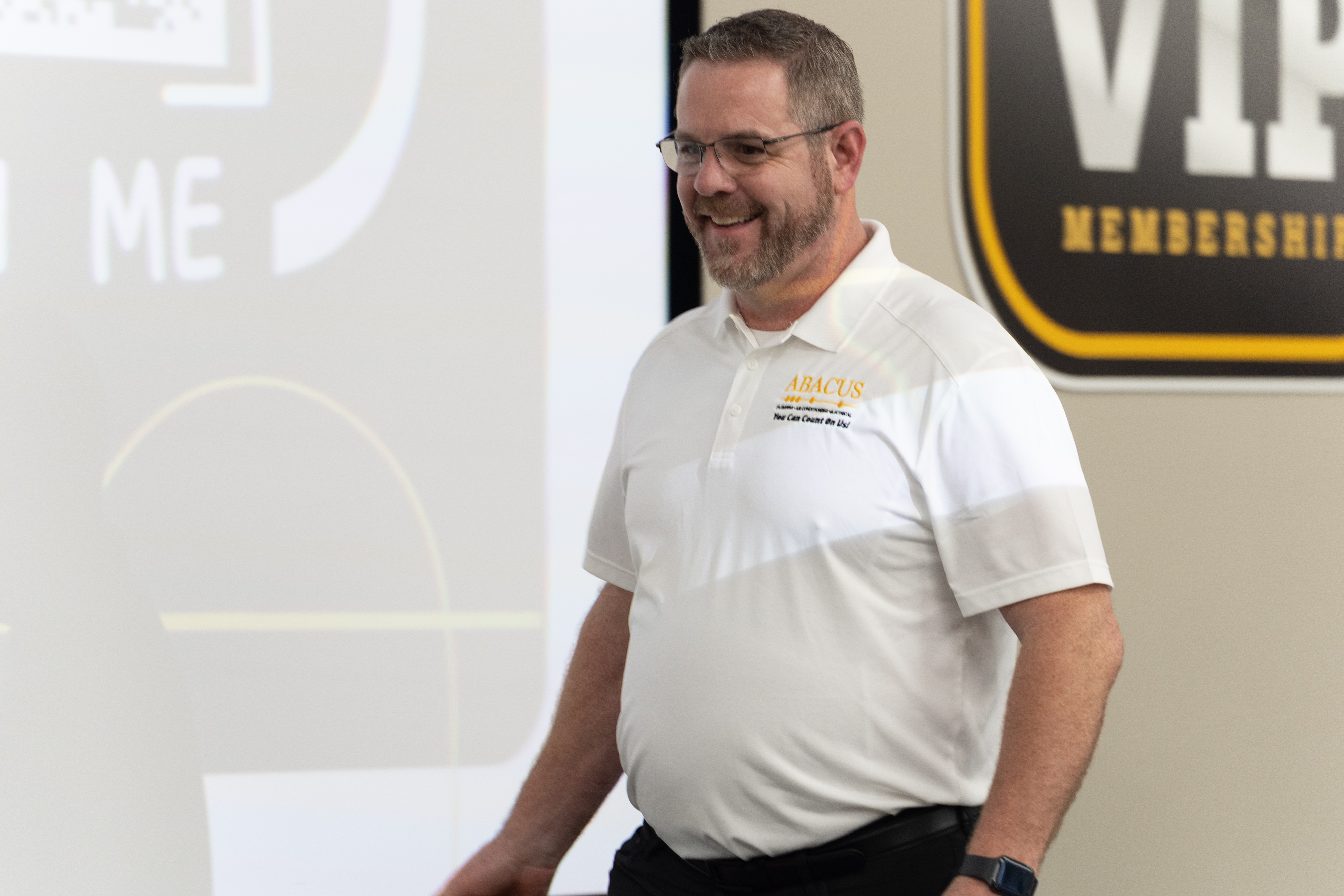 Abacus Plumbing, Air Conditioning, & Electrical shows a knowledgeable team member presenting benefits and building trust with customers.