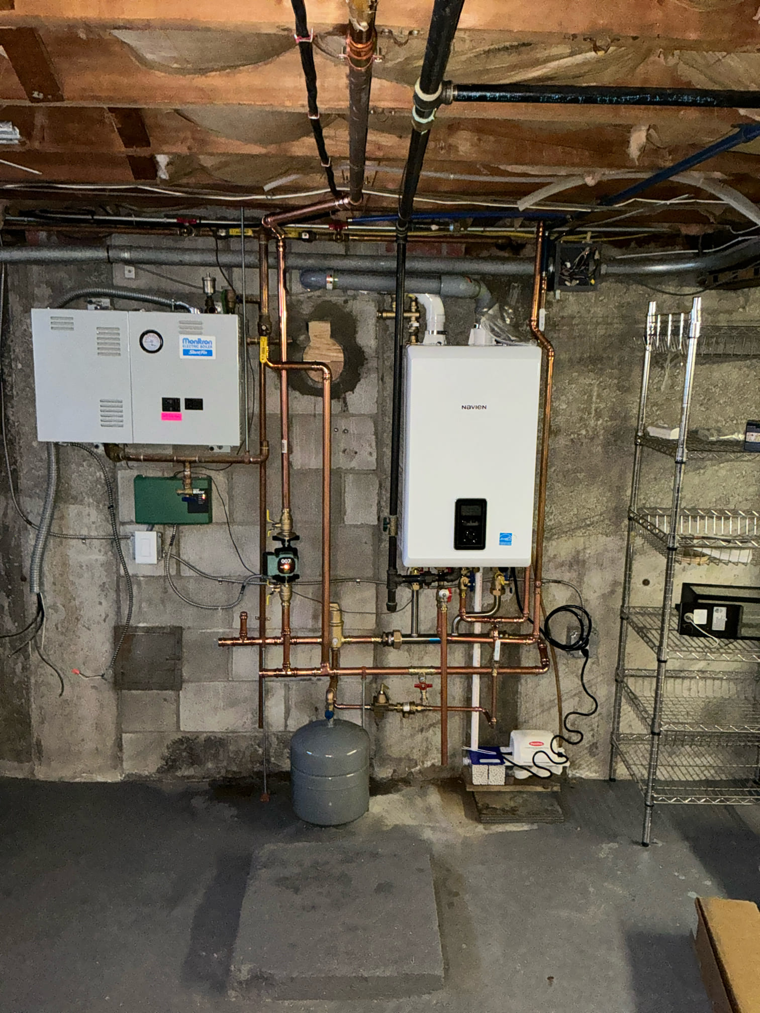 At Akian Plumbing, Heating, Cooling & Electric, we ensure your home systems are both efficient and expertly installed, as seen in this organized heating setup.