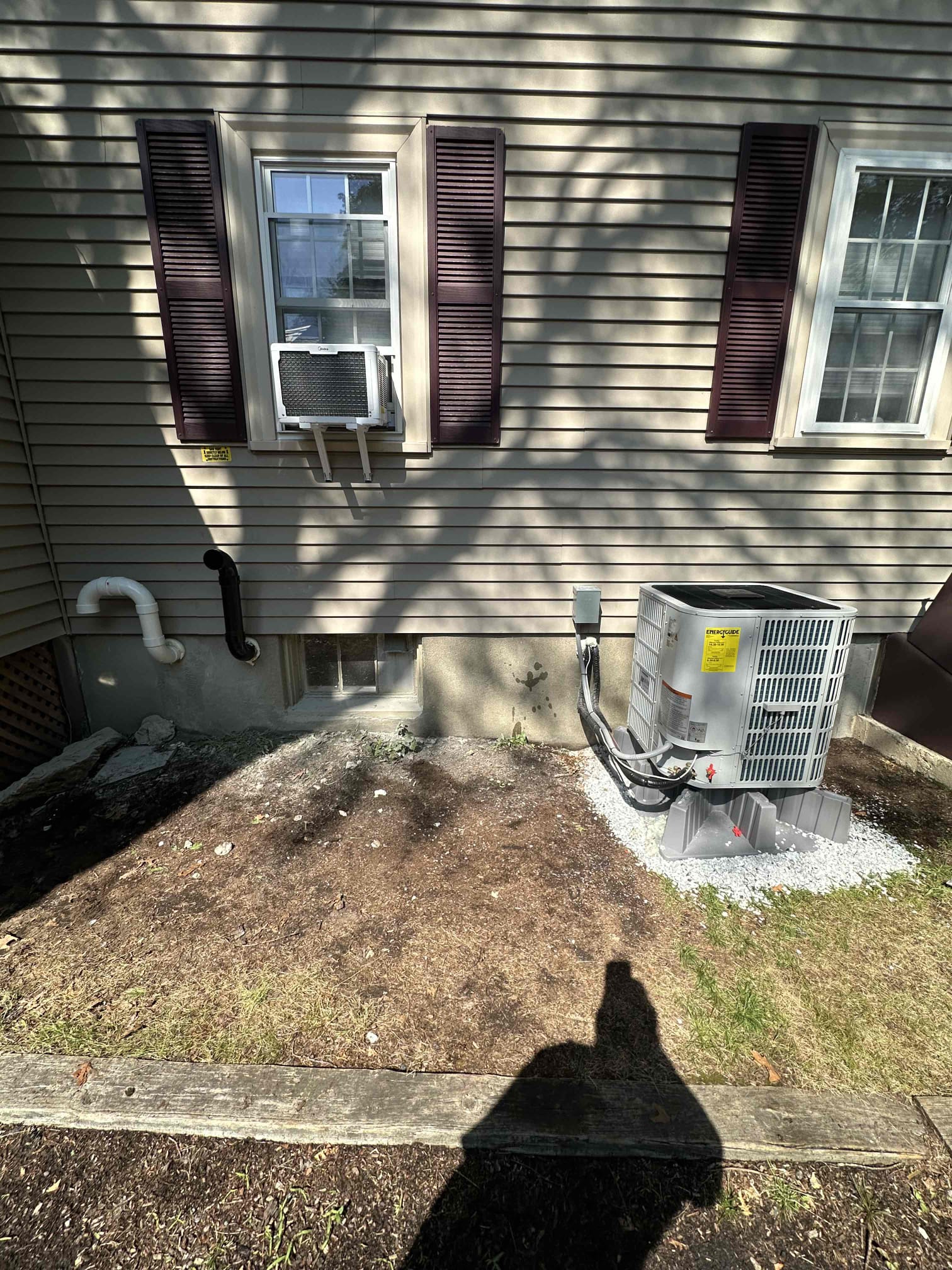 Akian Plumbing, Heating, Cooling & Electric demonstrates dependable HVAC service with a neatly installed outdoor condenser and tidy window unit.