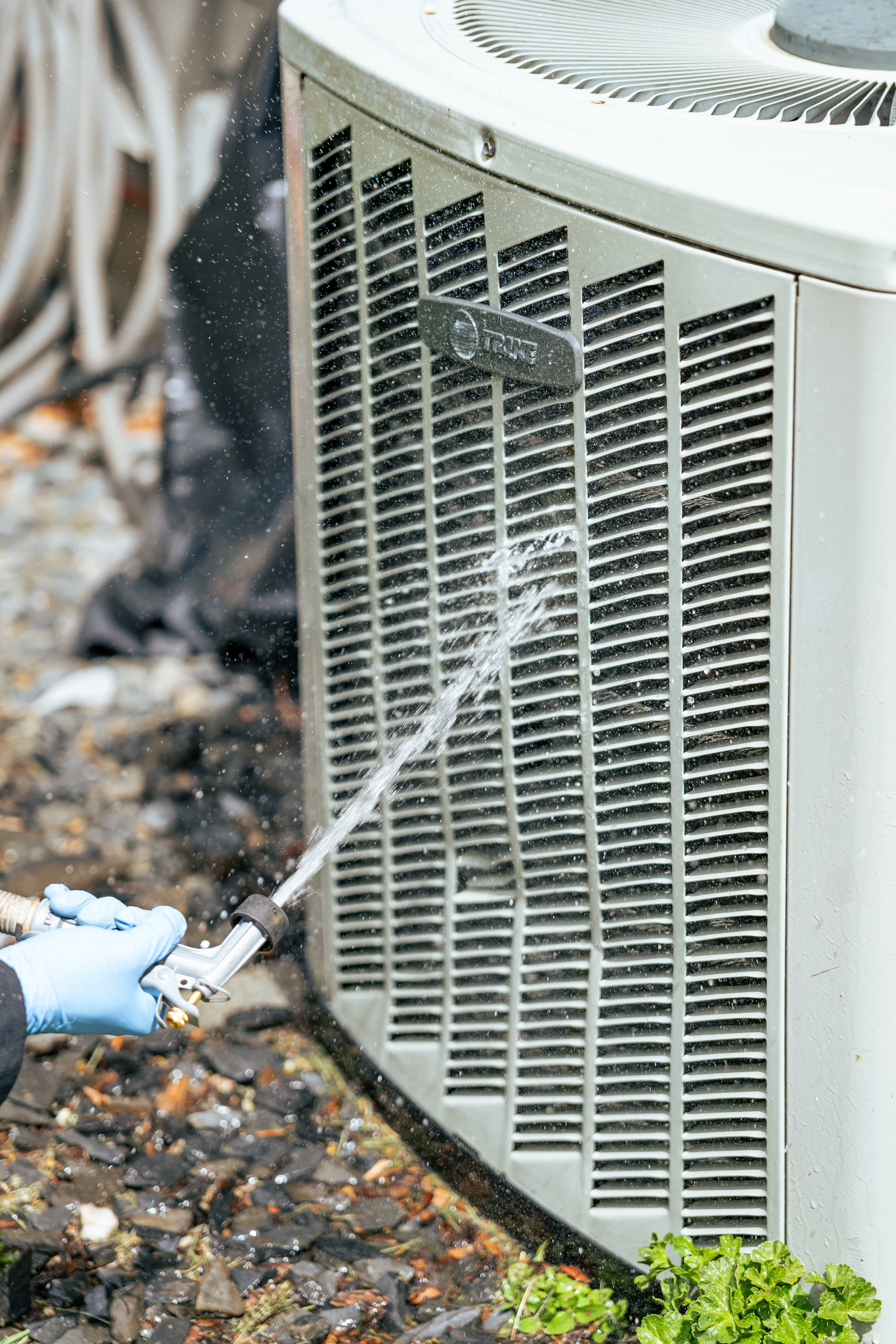 Careful preventative cleaning keeps systems running reliably, shown here by Lloyd Plumbing, Heating, Air, Electrical during routine HVAC maintenance.