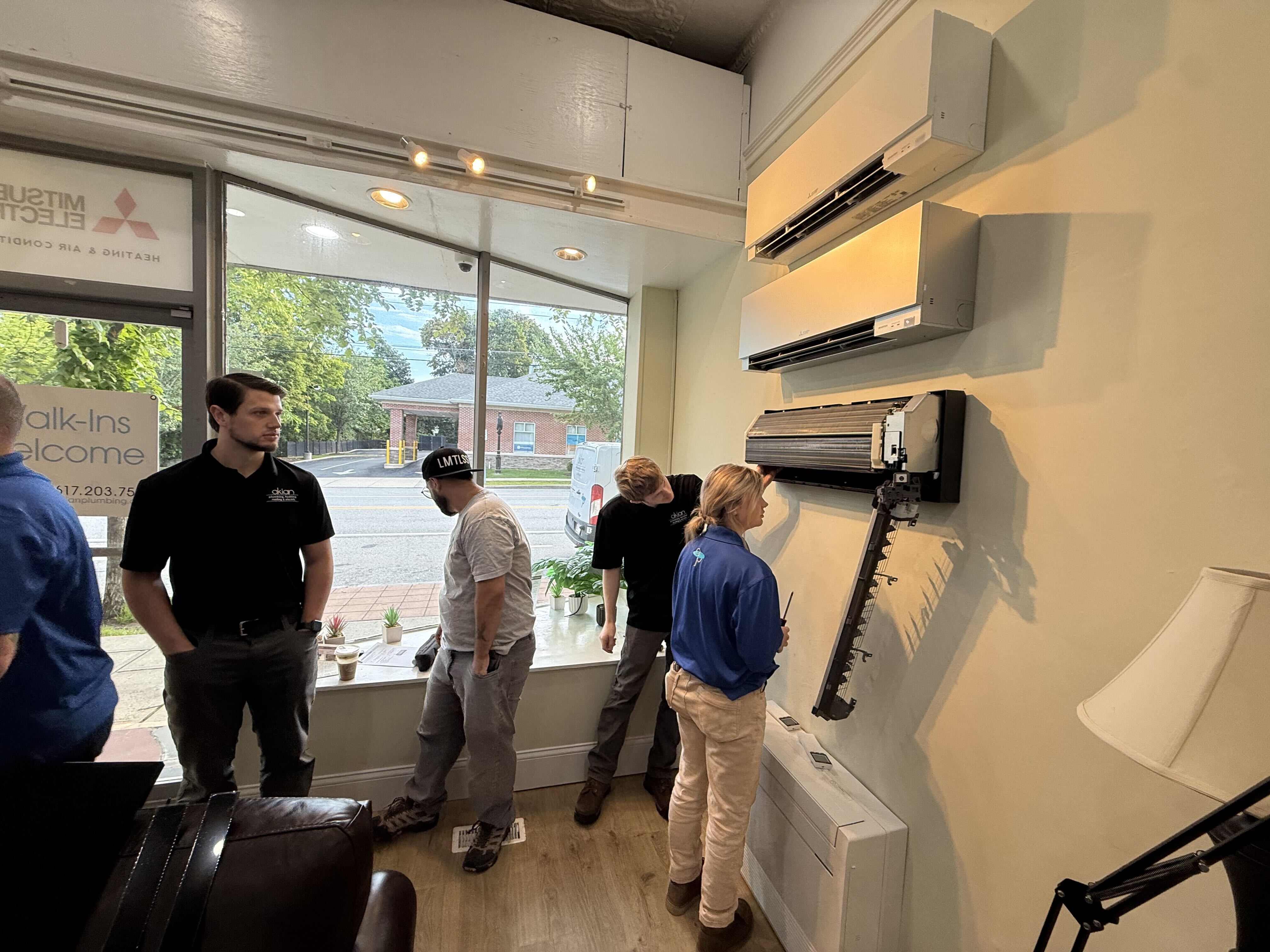 Customers trust Akian Plumbing, Heating, Cooling & Electric for professional ductless mini-split service, shown here with focused hands-on care.