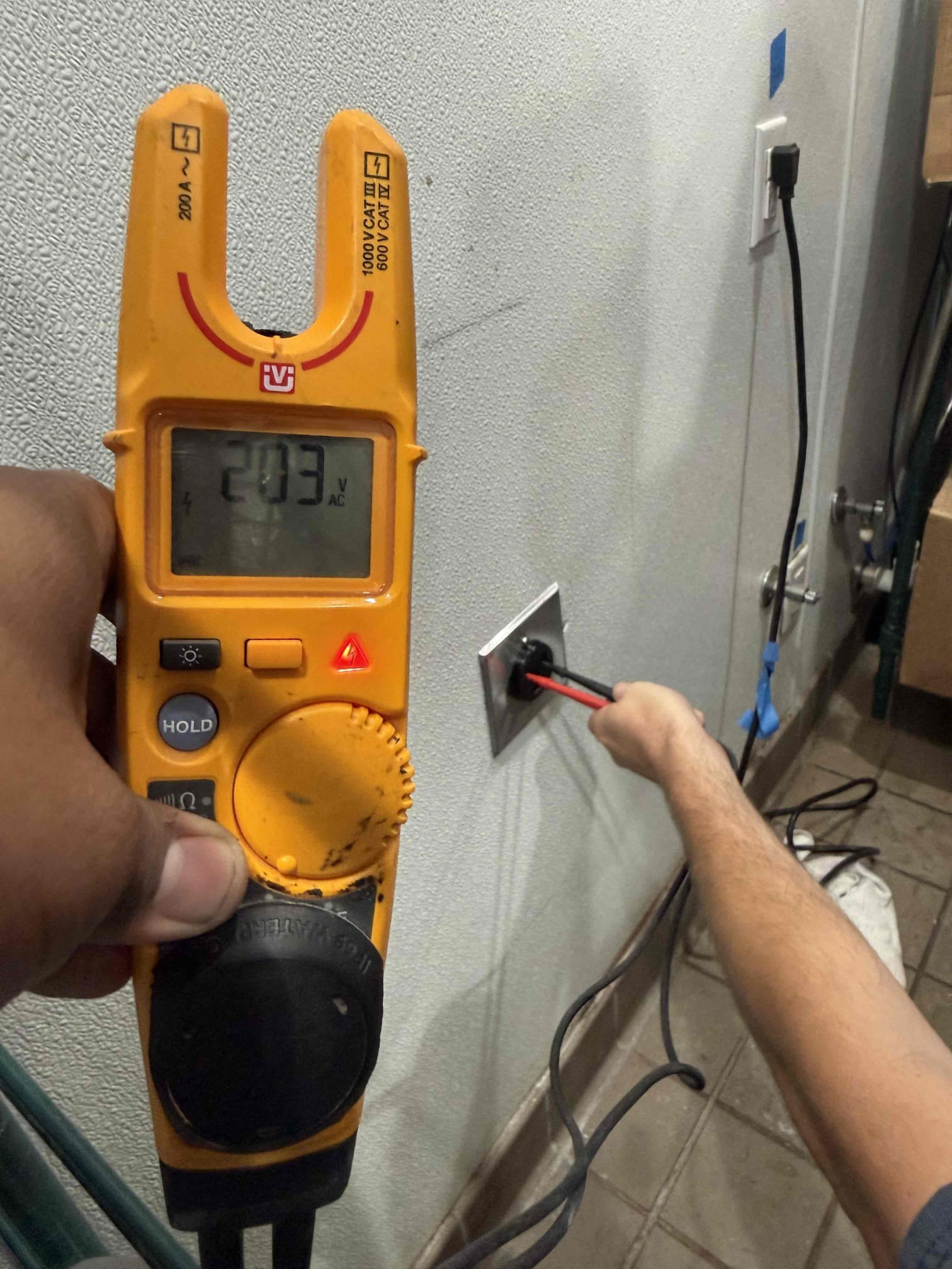 Powell Electric demonstrates careful, professional outlet testing to ensure safe, reliable service and peace of mind for customers.