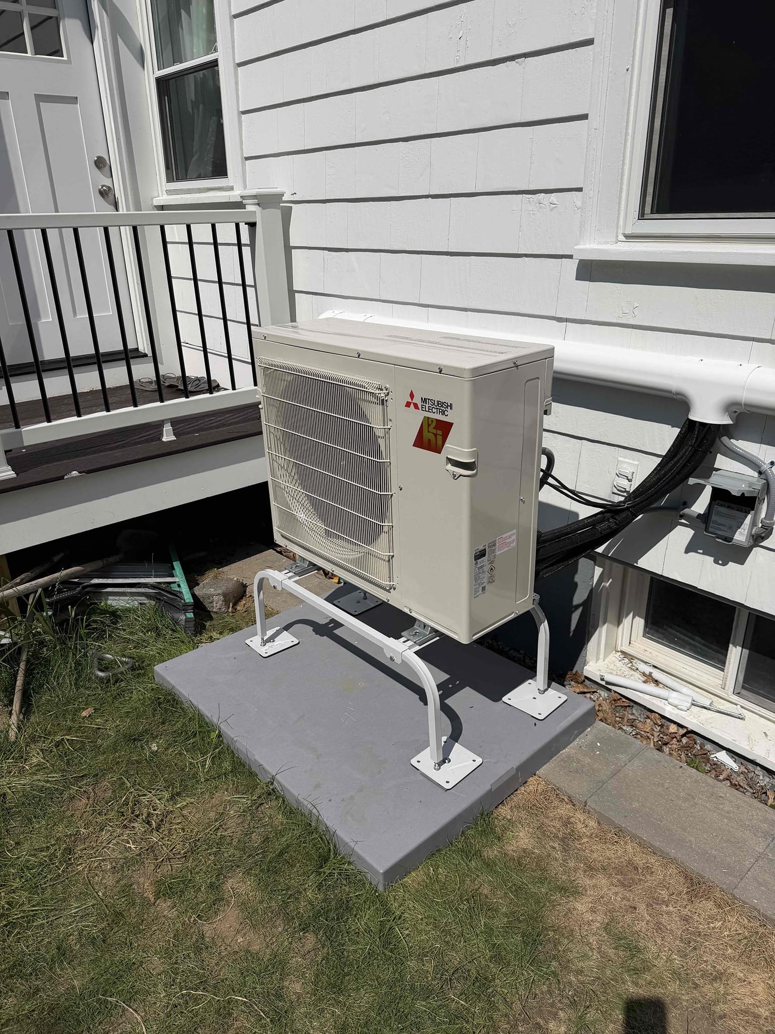 A neat, professionally mounted Mitsubishi Electric outdoor unit shows the dependable craftsmanship customers expect from Akian Plumbing, Heating, Cooling & Electric.