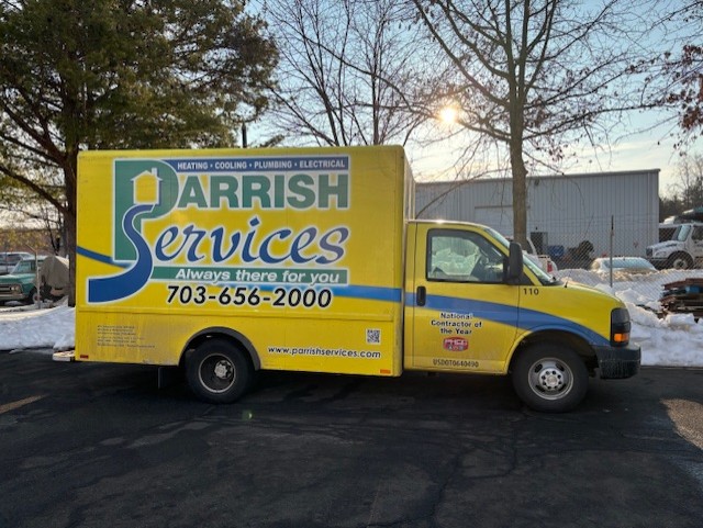 A bright Parrish Services truck parked and ready to respond, showcasing dependable branding that signals fast, professional service.