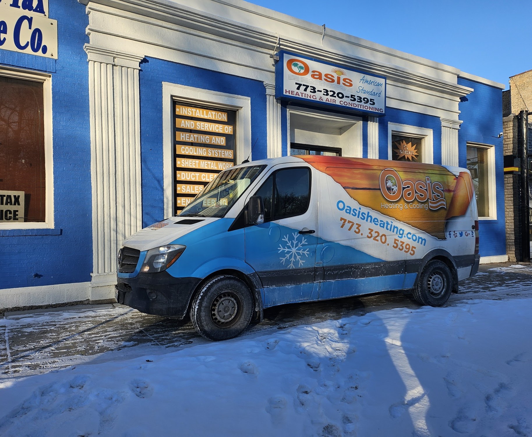 A well-branded van and clear storefront show Oasis Heating and Cooling’s professional presence and dependable winter service.
