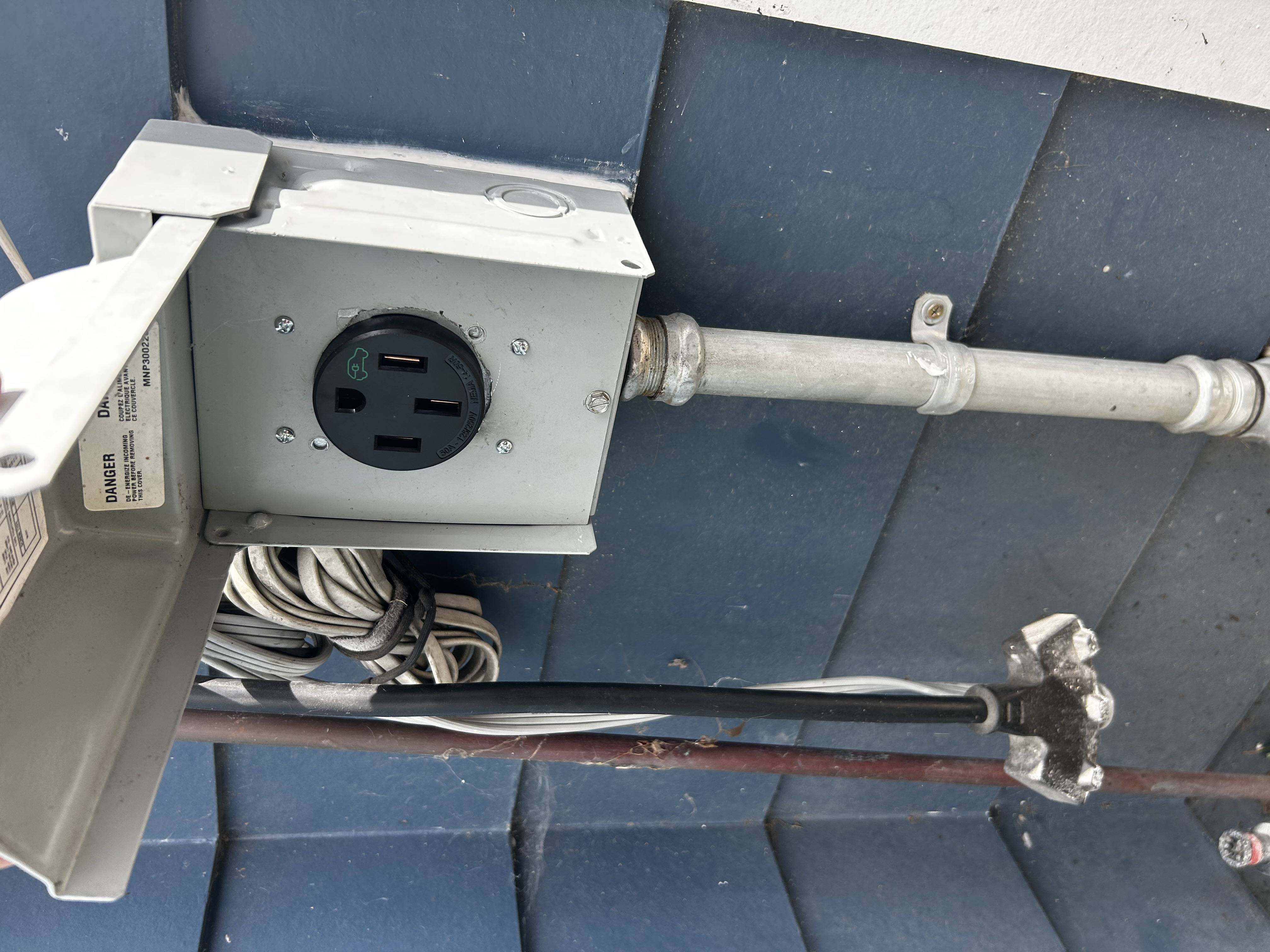 Powell Electric installed a durable outdoor charging receptacle with tidy conduit work to ensure safe, reliable use for your EV.