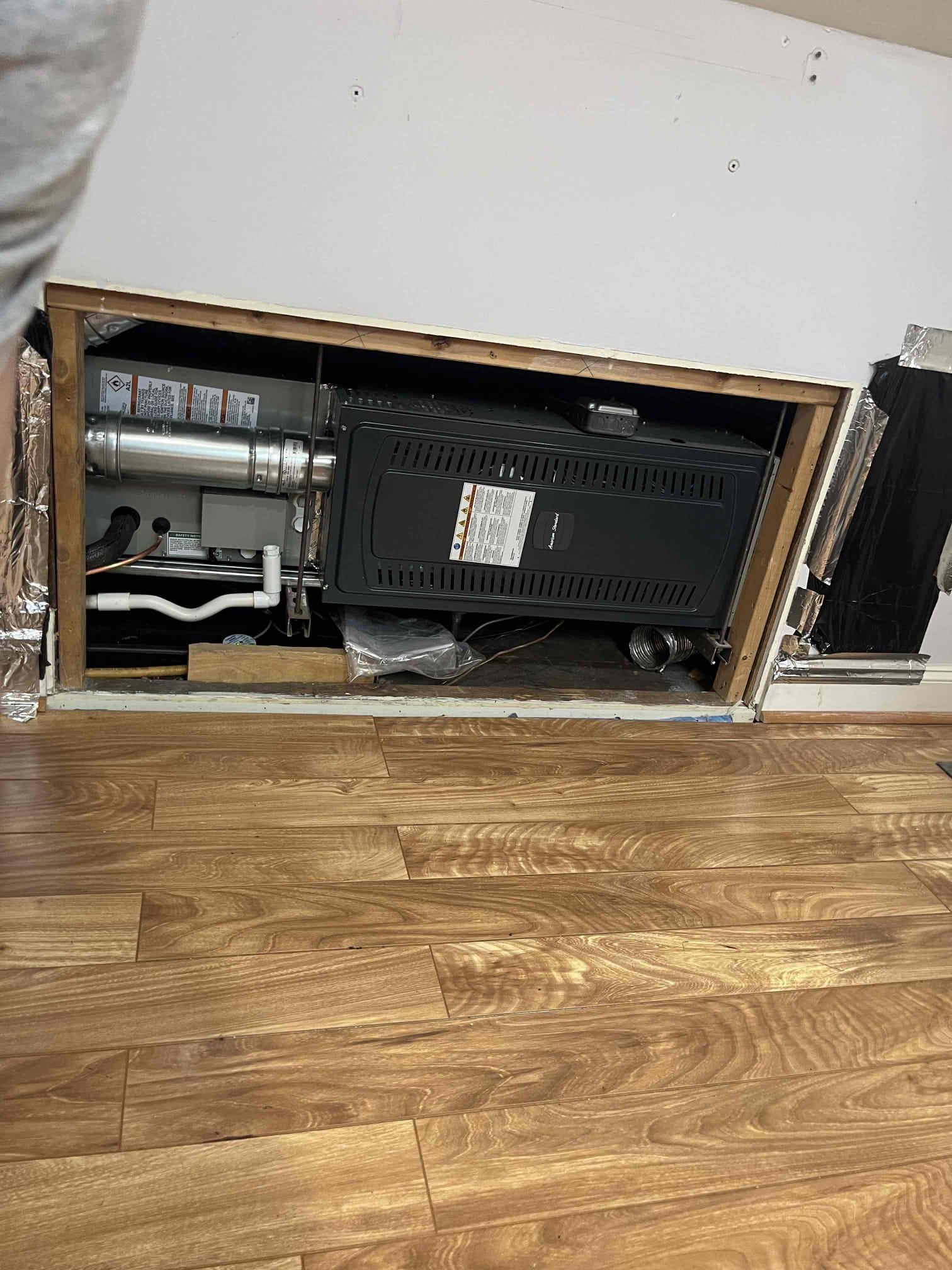 Akian Plumbing, Heating, Cooling & Electric demonstrates careful installation and tidy work protecting floors while ensuring reliable HVAC performance.
