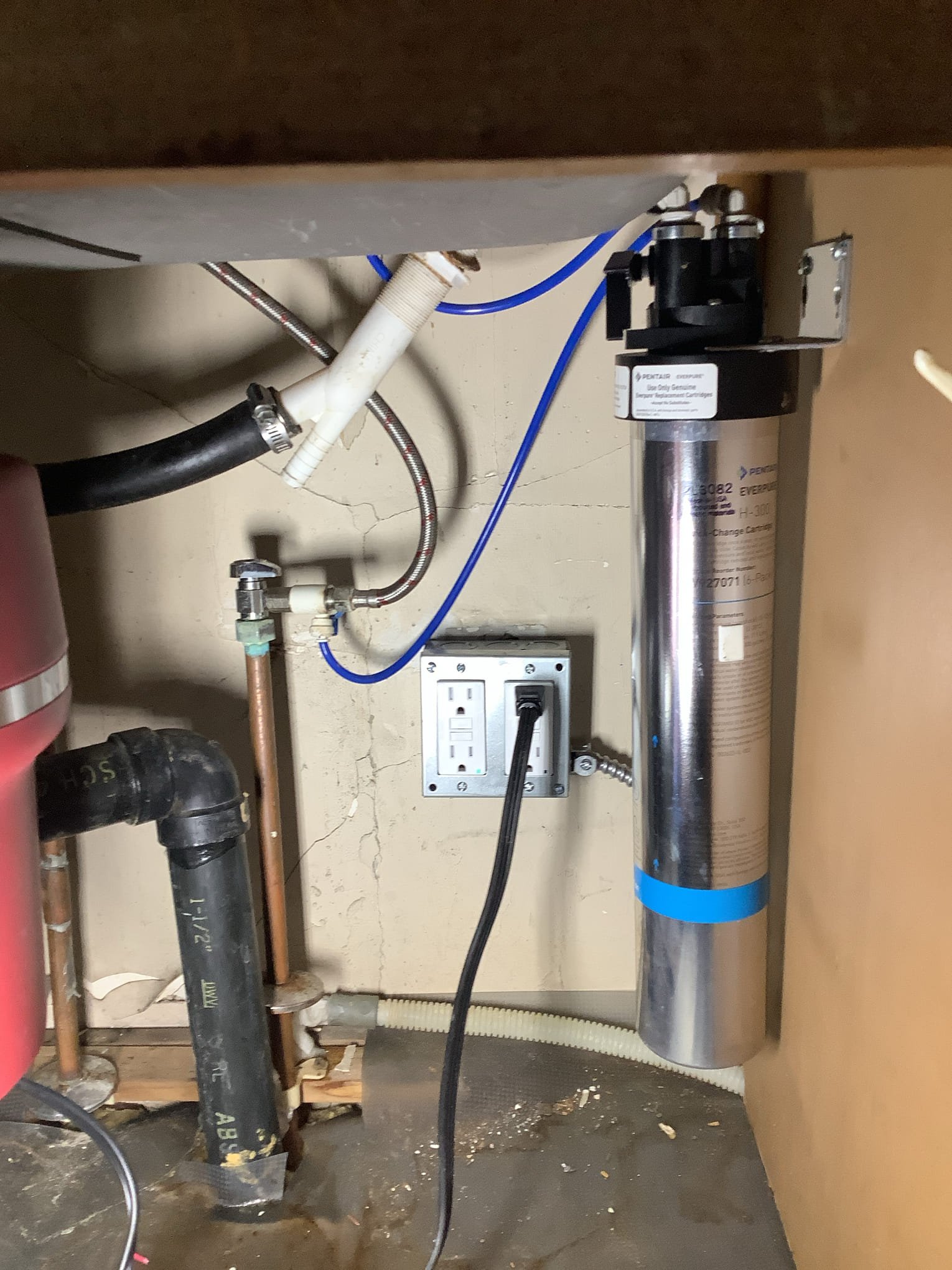 Powell Electric ensures reliable under-sink water filtration installations with neat tubing and secure electrical protection for lasting safety.