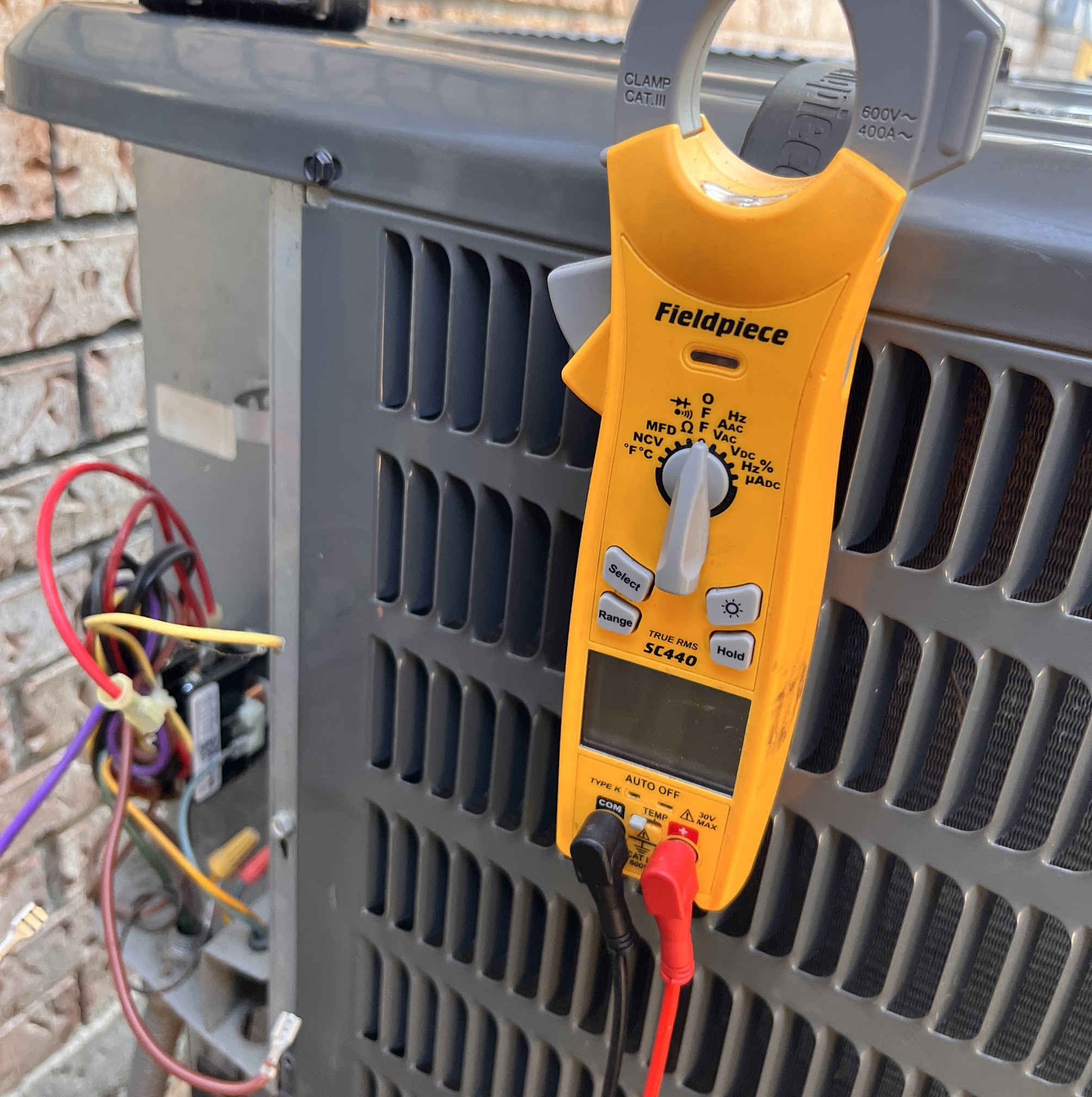 Professional diagnostic testing on an outdoor unit shows Abacus Plumbing, Air Conditioning & Electrical delivering reliable HVAC service with care.