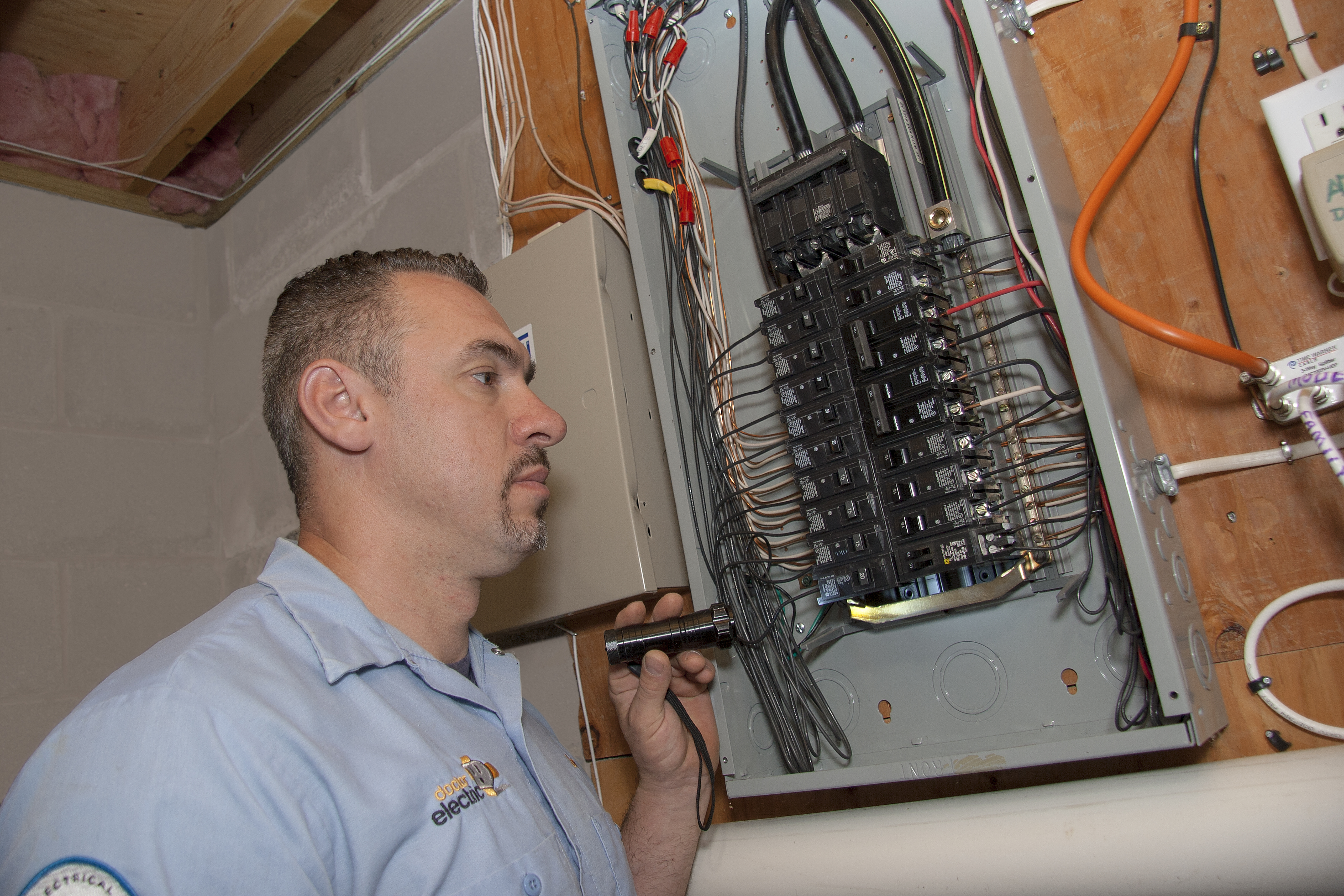 A Doctor Electric technician inspects your home's electrical panel with careful attention to safety and reliable workmanship.