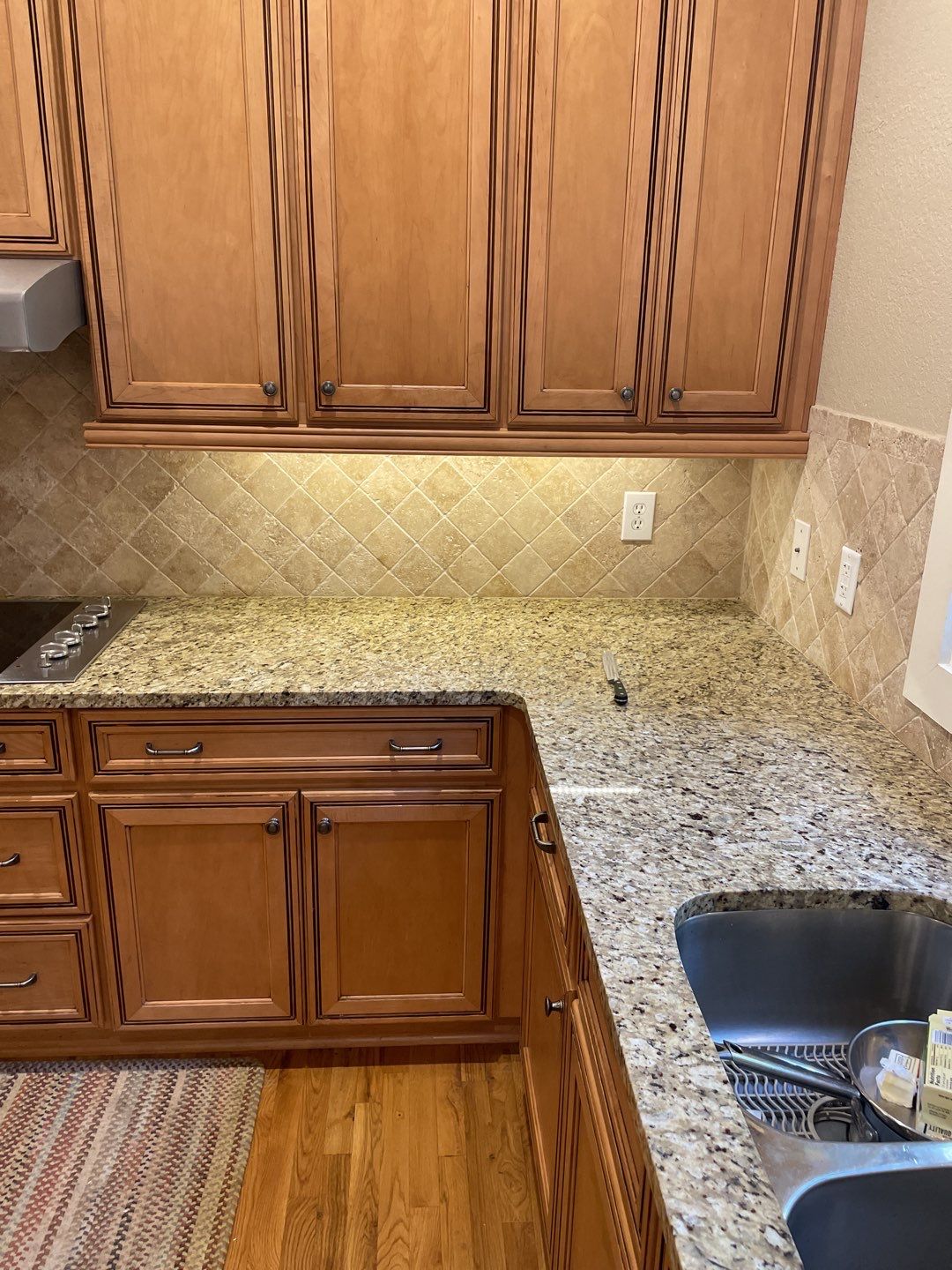 Bright under-cabinet lighting and precise backsplash work show how C&T Electric LLC enhances kitchen safety and lasting value.