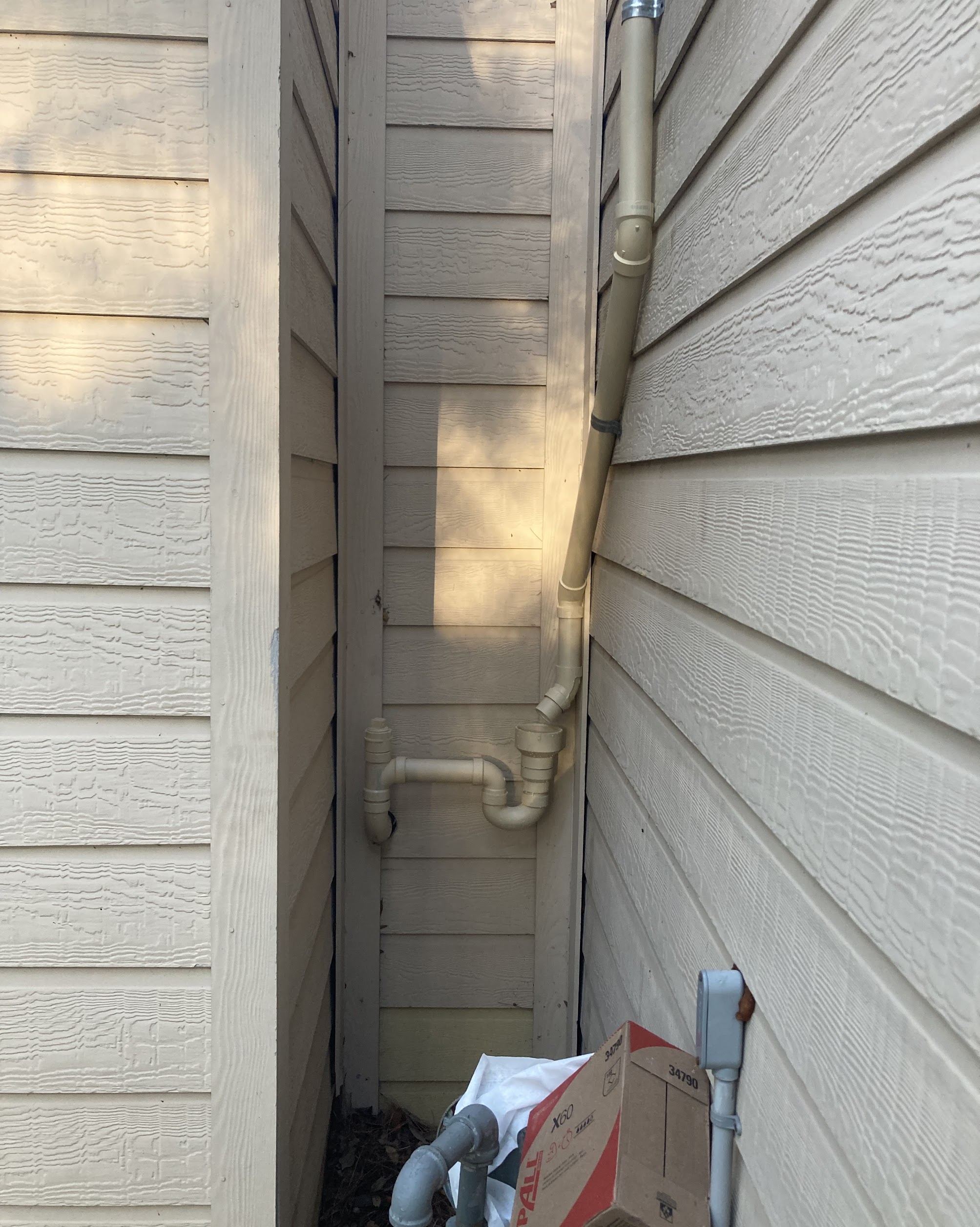 Showcasing careful pipe routing and tidy exterior work, Abacus Plumbing, Air Conditioning & Electrical demonstrates reliable craftsmanship even in tight spaces.