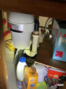 A neatly installed garbage disposal and tidy under-sink plumbing showcase Cardinal Plumbing Heating & Air Inc's reliable workmanship and care.