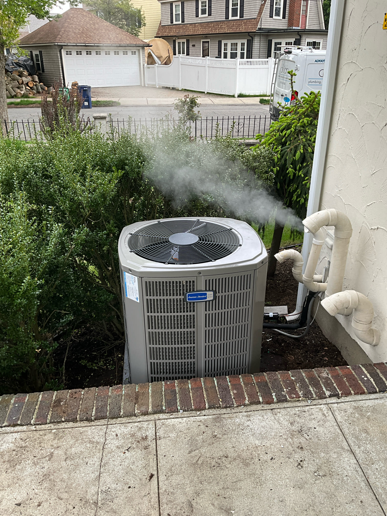 Trust Akian Plumbing, Heating, Cooling & Electric for reliable outdoor HVAC service, shown here with a clean condenser and visible system operation.