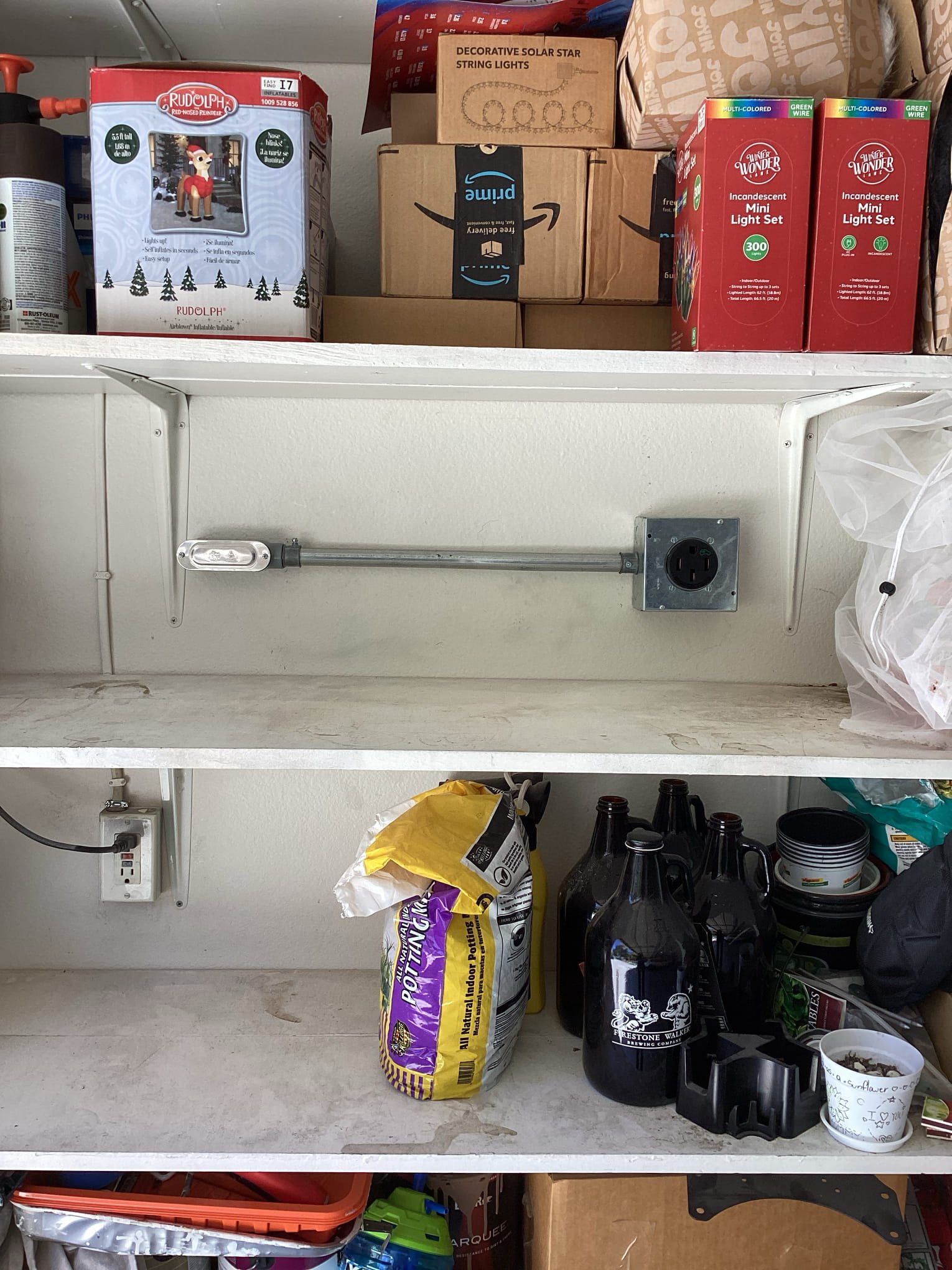 Powell Electric installed tidy conduit and a secure junction box for reliable, code‑minded electrical safety in this garage.