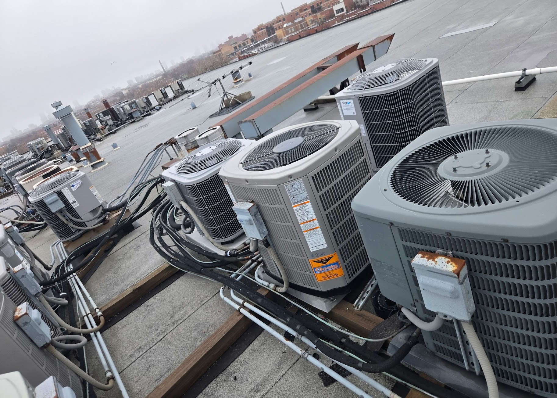 Clean rooftop installations and organized piping showcase the reliable craftsmanship customers trust from Oasis Heating and Cooling.