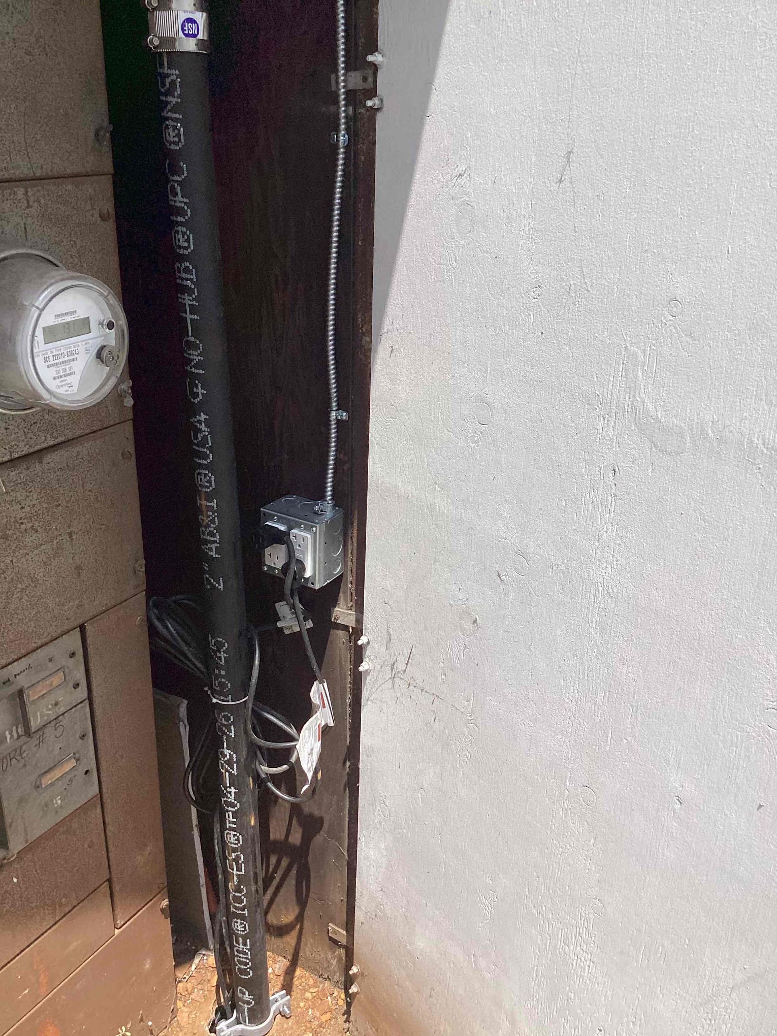 Powell Electric demonstrates careful outdoor service work with secure conduit and a weatherproof outlet for reliable, long‑lasting performance.