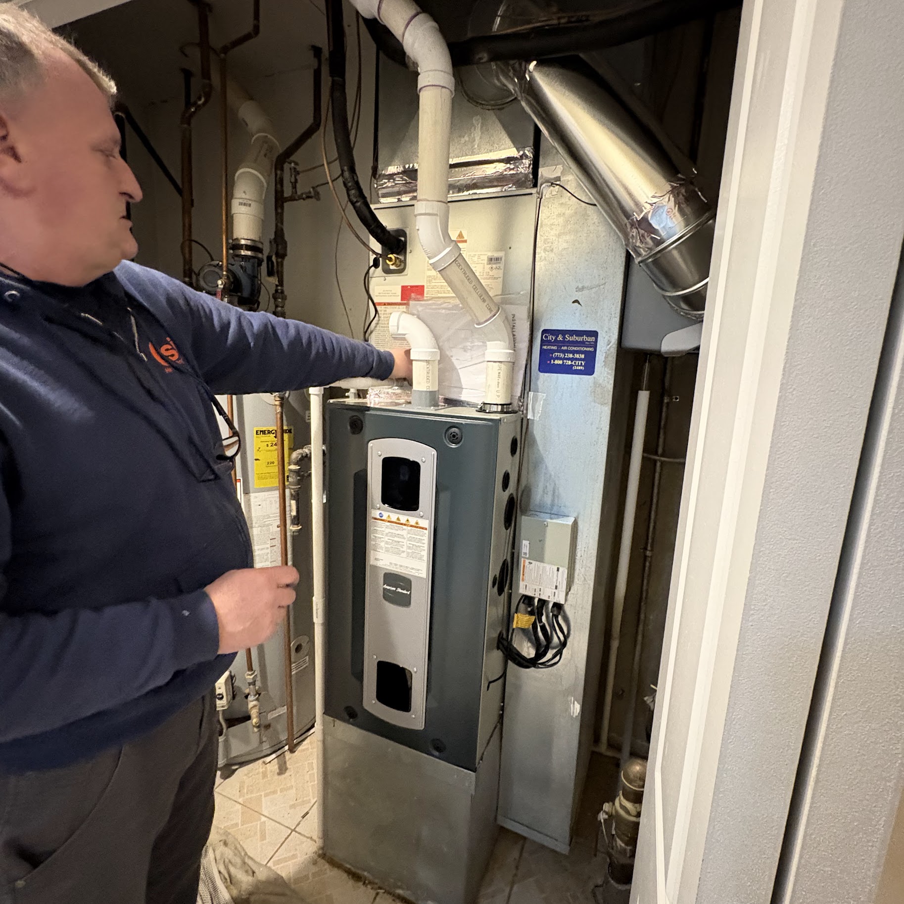 A certified technician explains the completed furnace service with confidence, showing Oasis Heating and Cooling's commitment to reliable home comfort.