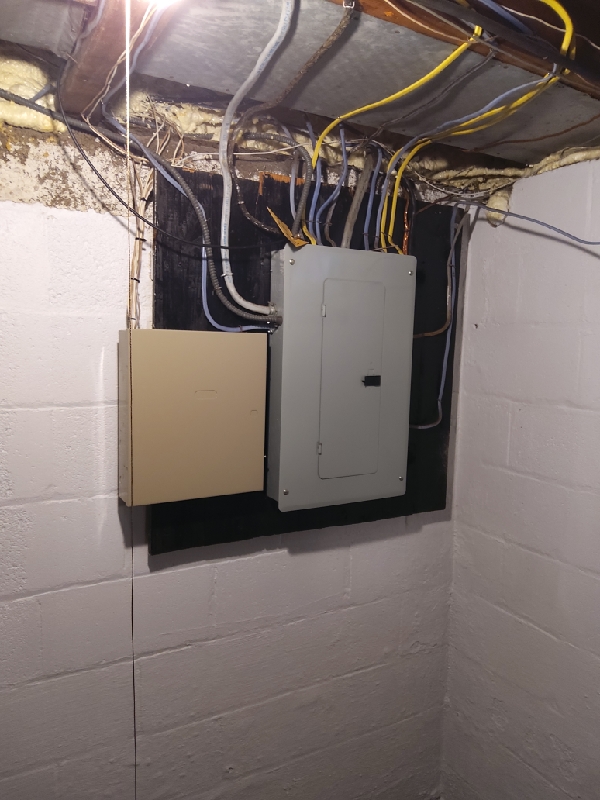 Doctor Electric shows dependable, neatly installed electrical panels in a basement setting, demonstrating careful workmanship and safety awareness.