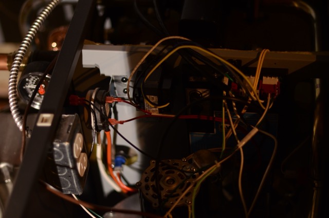 Behind-the-scenes precision work from Lloyd Plumbing, Heating, Air, Electrical shows careful wiring and methodical service inside a home system.