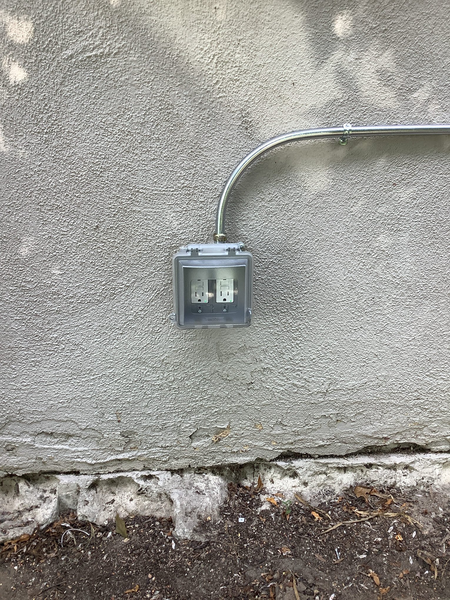 Powell Electric installed a neat weatherproof outdoor outlet with secure conduit bends to keep your home safe and code compliant.