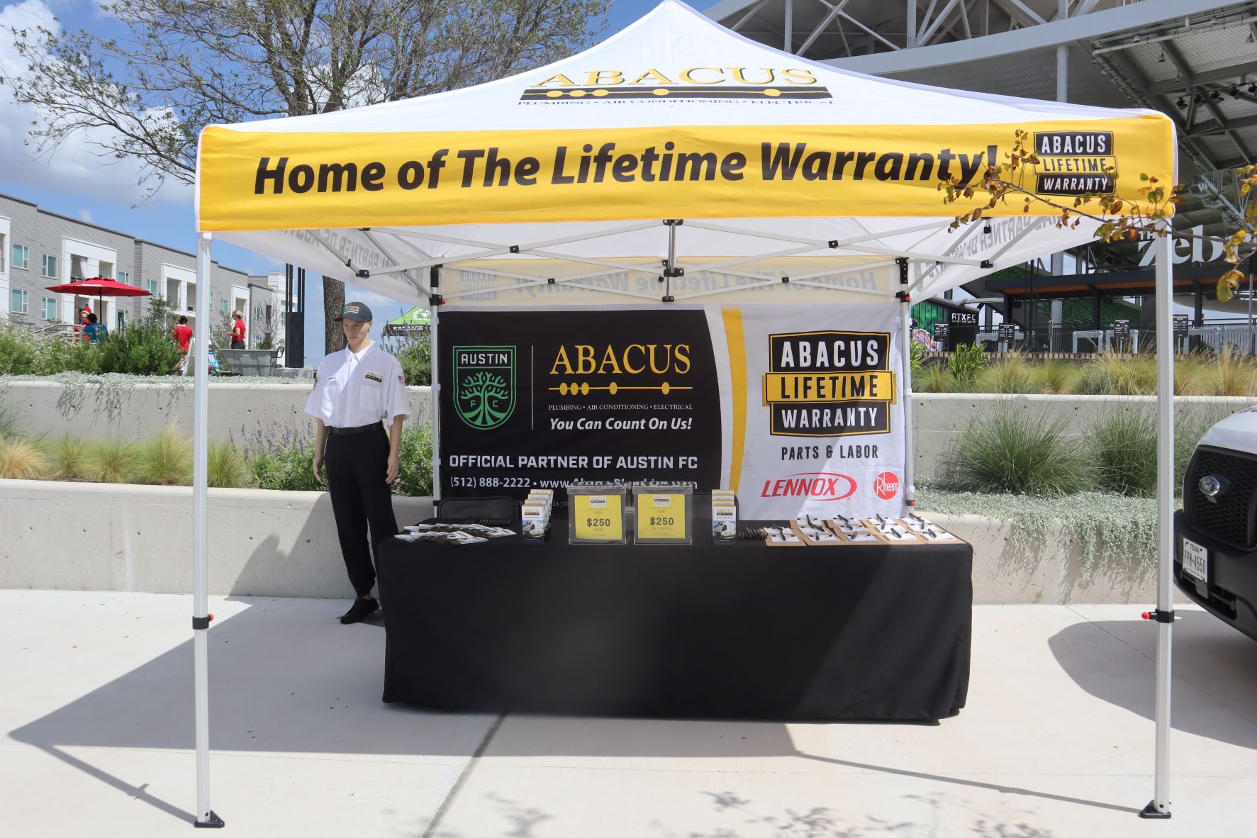 Abacus Plumbing, Air Conditioning, & Electrical showcases trusted craftsmanship and a lifetime warranty at a local event to build customer confidence.