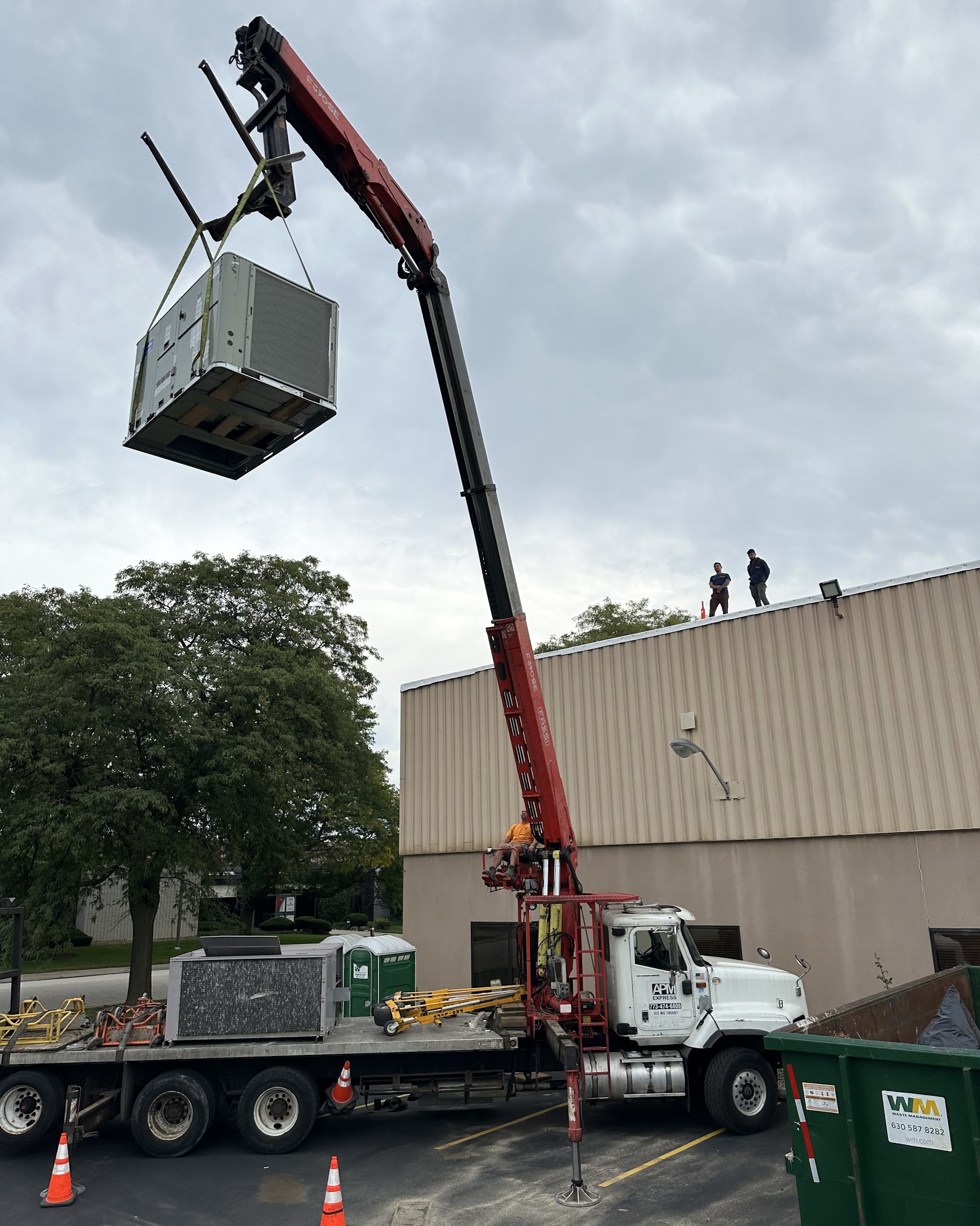 Oasis Heating and Cooling demonstrates careful, professional rooftop equipment installs with trained technicians overseeing a safe crane lift.
