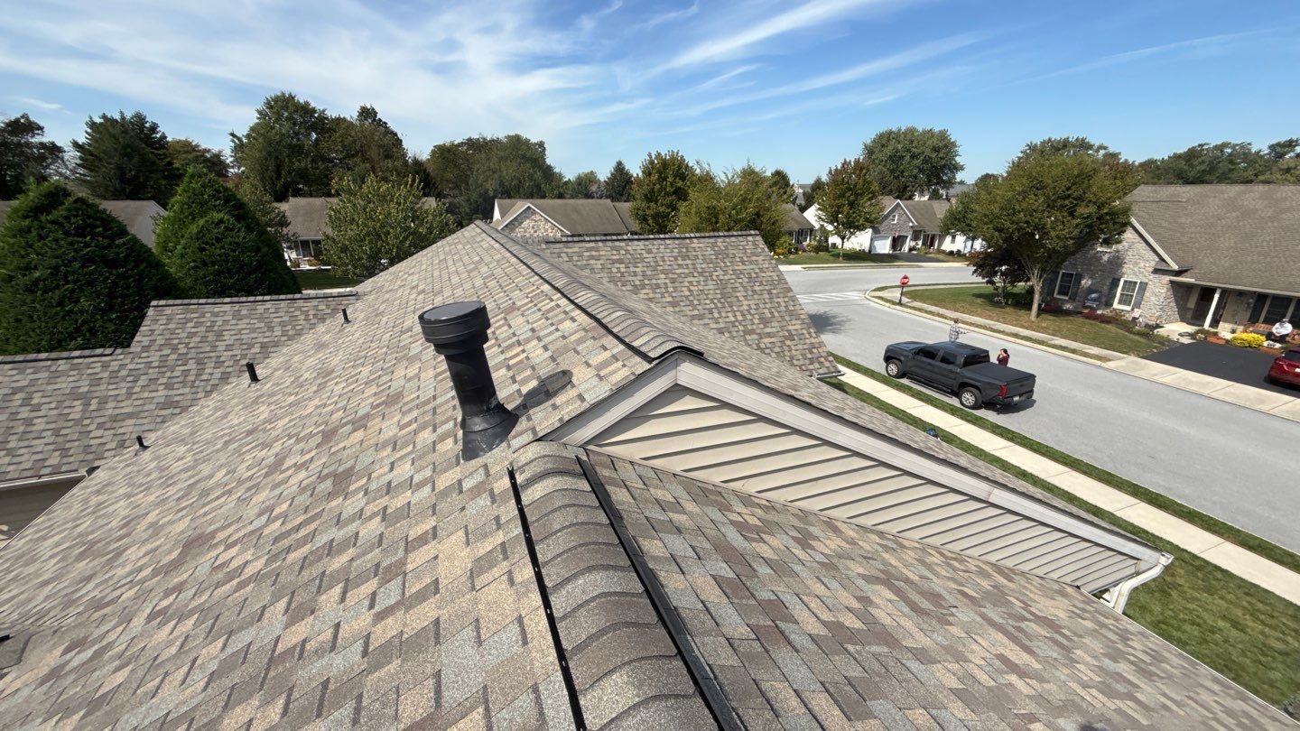 Showcasing durable, neatly installed asphalt shingles and precise ridge work, Mosaic Roofing & Exteriors delivers reliable residential roof craftsmanship.