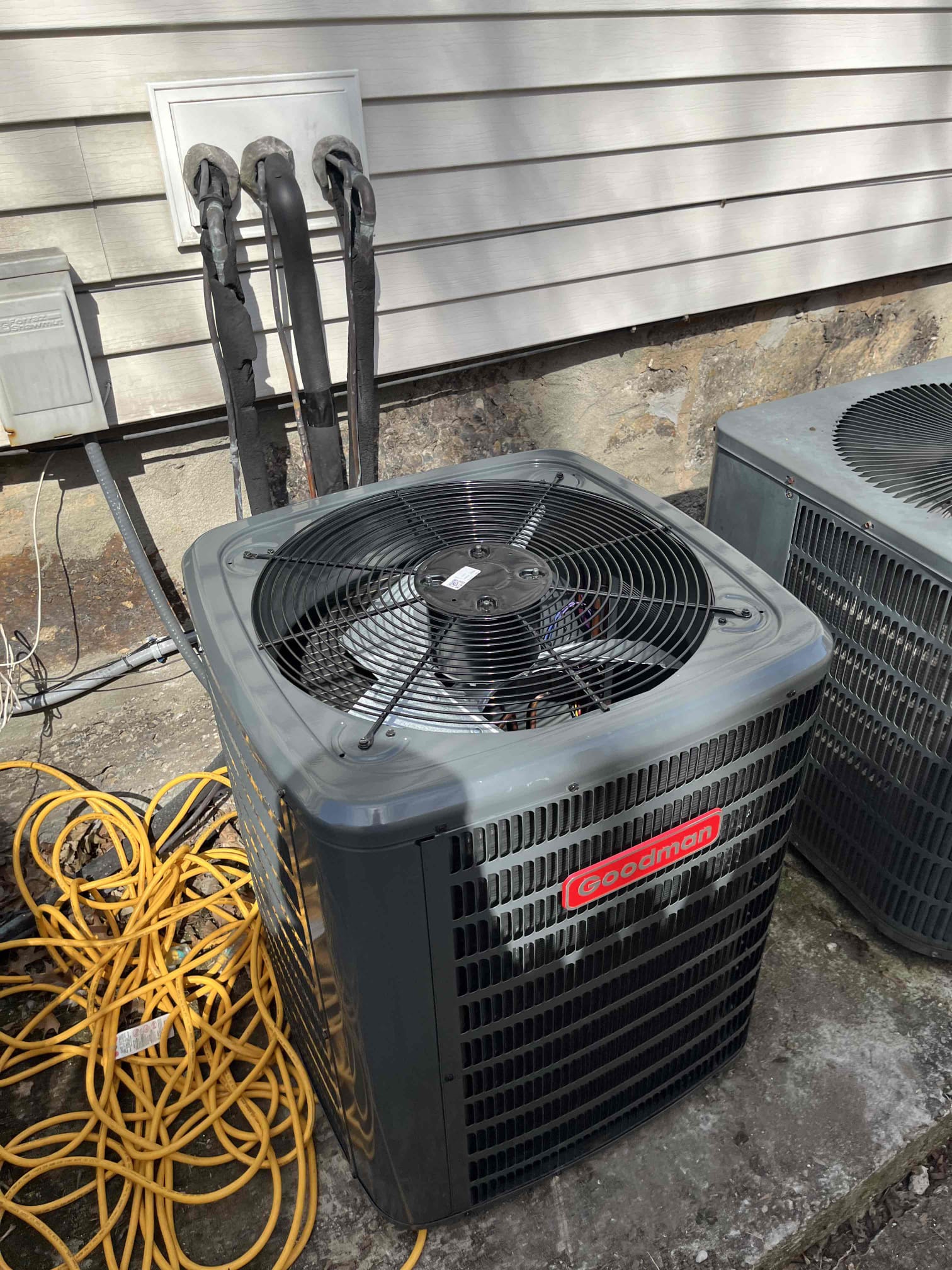 A clean Goodman outdoor unit shows reliable craftsmanship and value for homeowners, installed and serviced by Akian Plumbing, Heating, Cooling & Electric.
