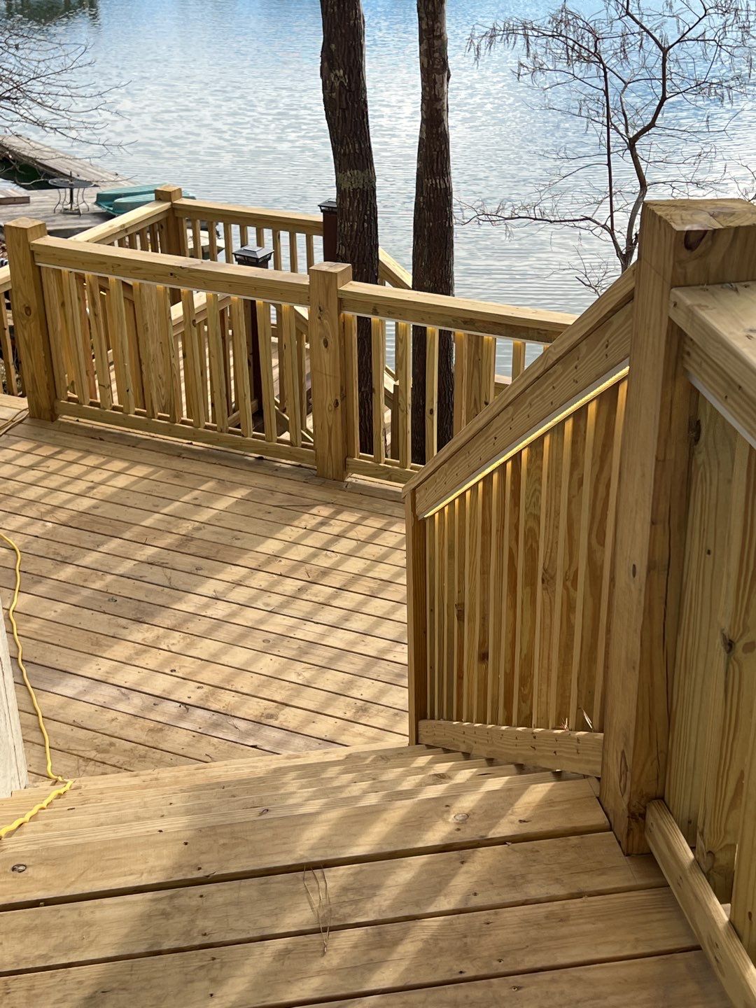 A freshly built lakeside deck showcases C&T Electric LLC quality and careful craftsmanship for comfortable outdoor living.