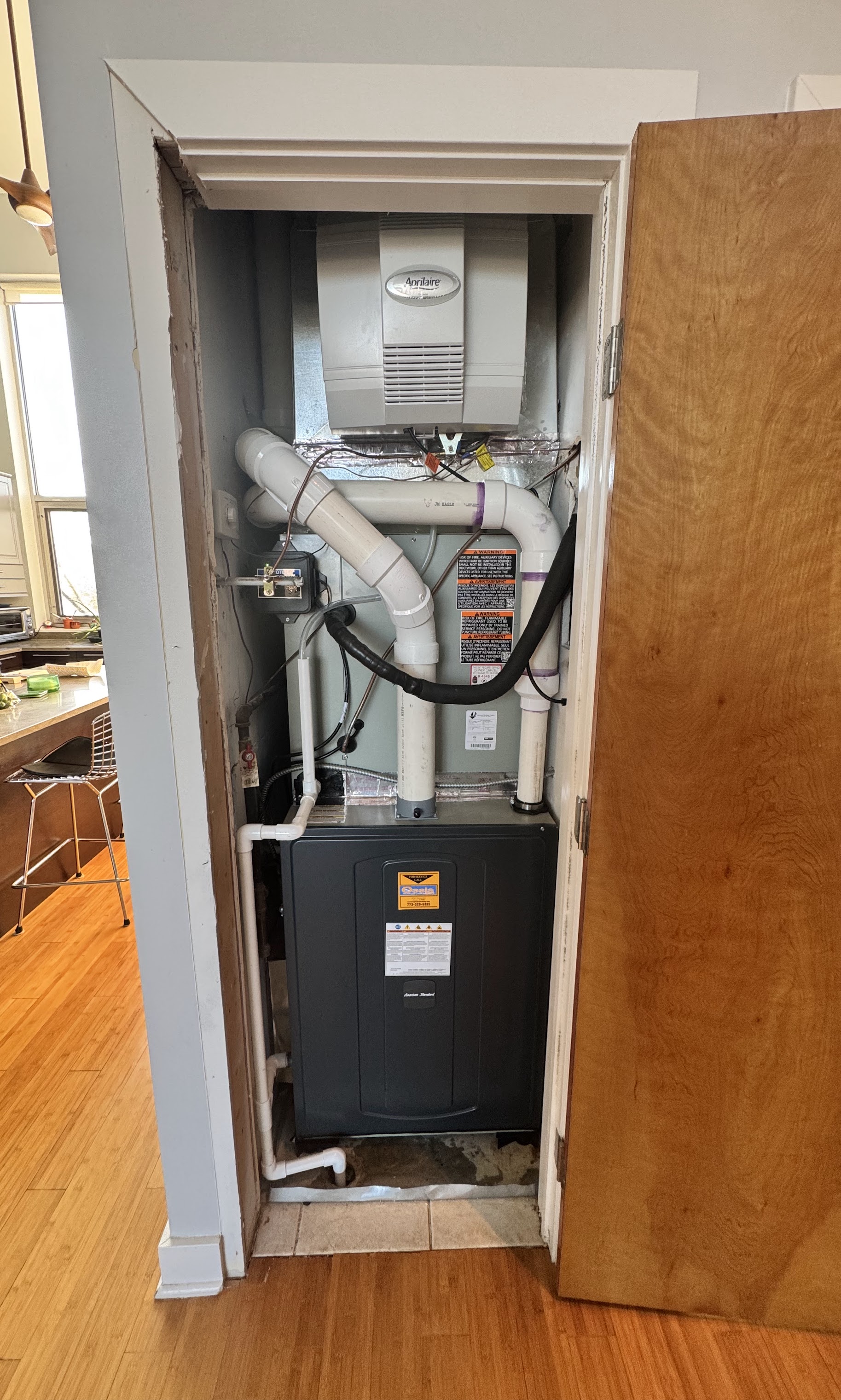 Clean, organized HVAC installation in a tight utility closet shows Oasis Heating and Cooling's reliable craftsmanship and attention to service.