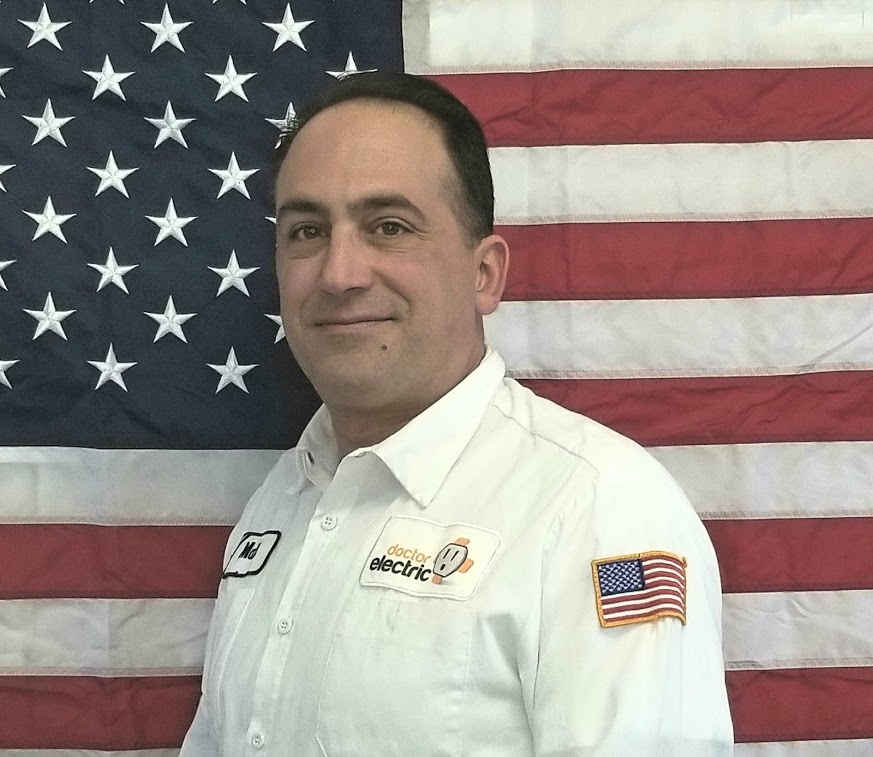 A friendly, professional technician in a clean Doctor Electric uniform stands ready to deliver trusted, prompt service with pride.