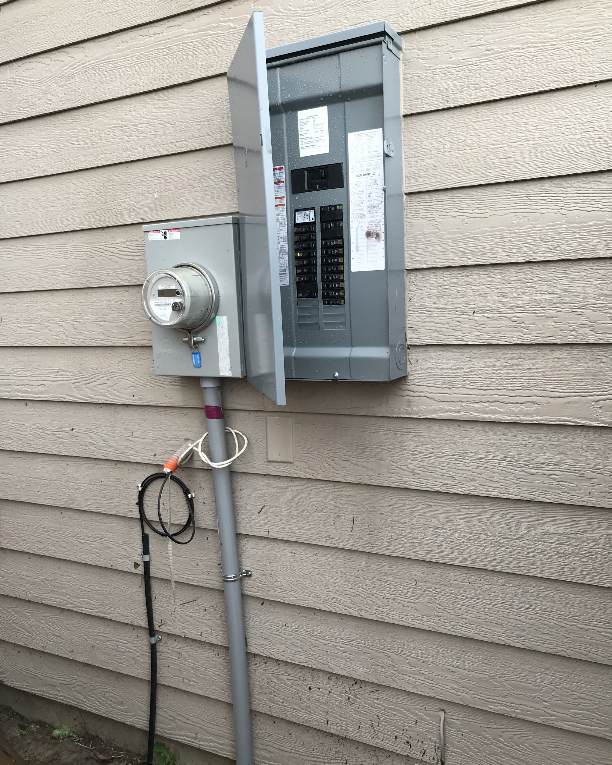 A clean, well-installed exterior breaker panel demonstrates the reliable electrical work customers trust from Abacus Plumbing, Air Conditioning & Electrical.
