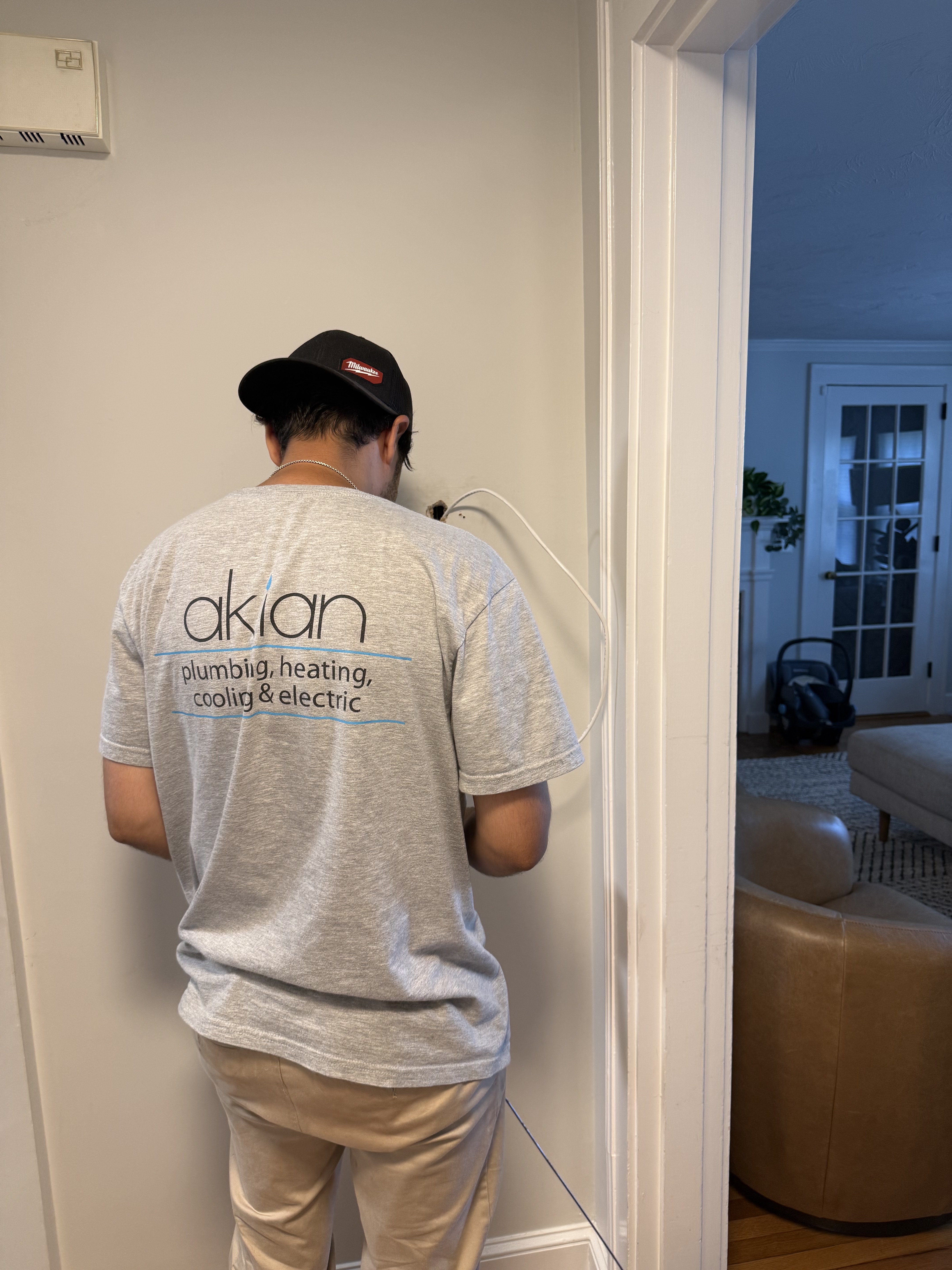 Akian Plumbing, Heating, Cooling & Electric demonstrates careful, on-site expertise while respecting your home during electrical and wiring work.