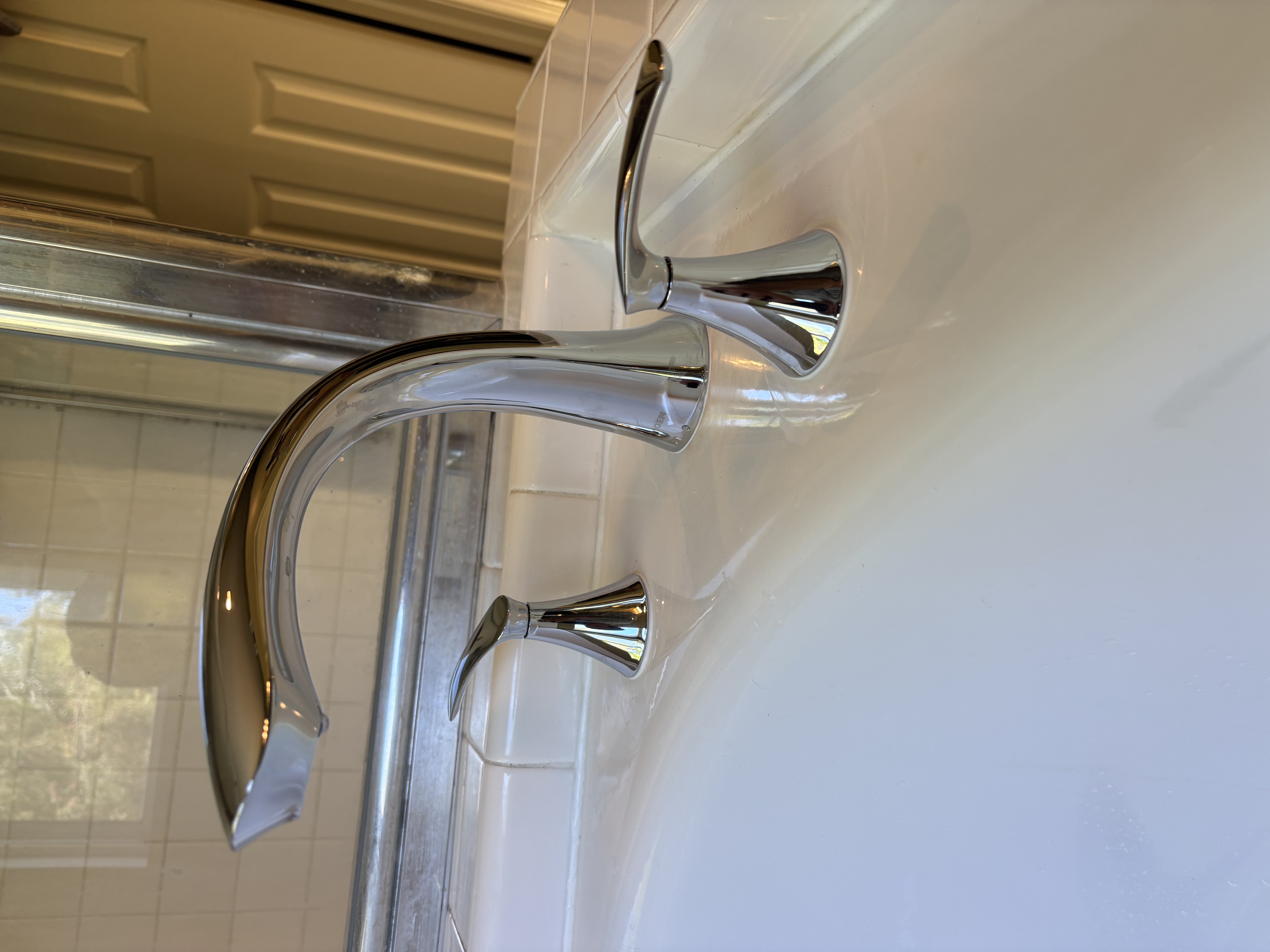 Bright chrome fixtures installed with care show Island Plumbing's commitment to neat, long-lasting bathroom workmanship.