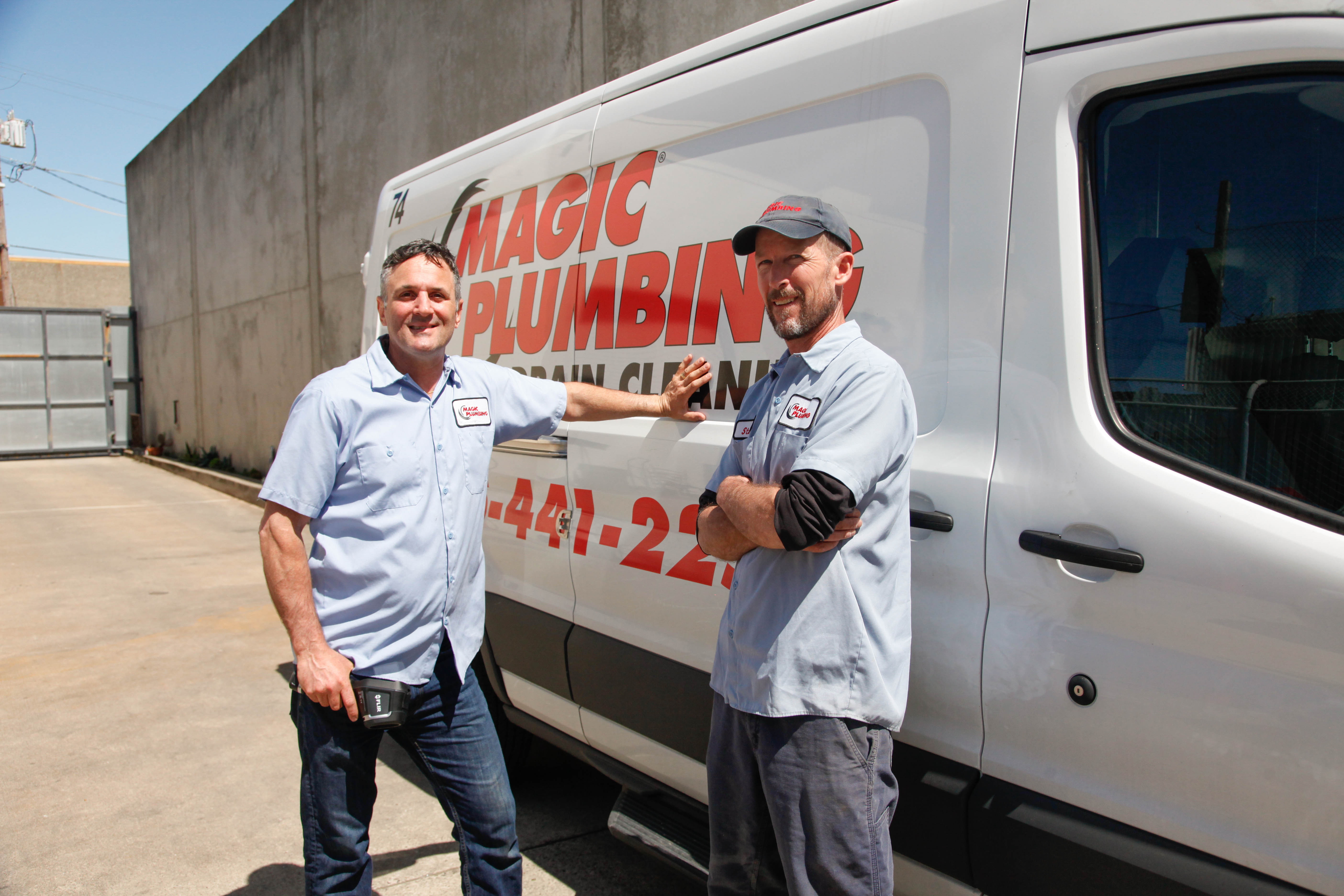 Smiling technicians and a clearly branded van showcase the reliable, professional service customers expect from Magic Plumbing Heating & Cooling.