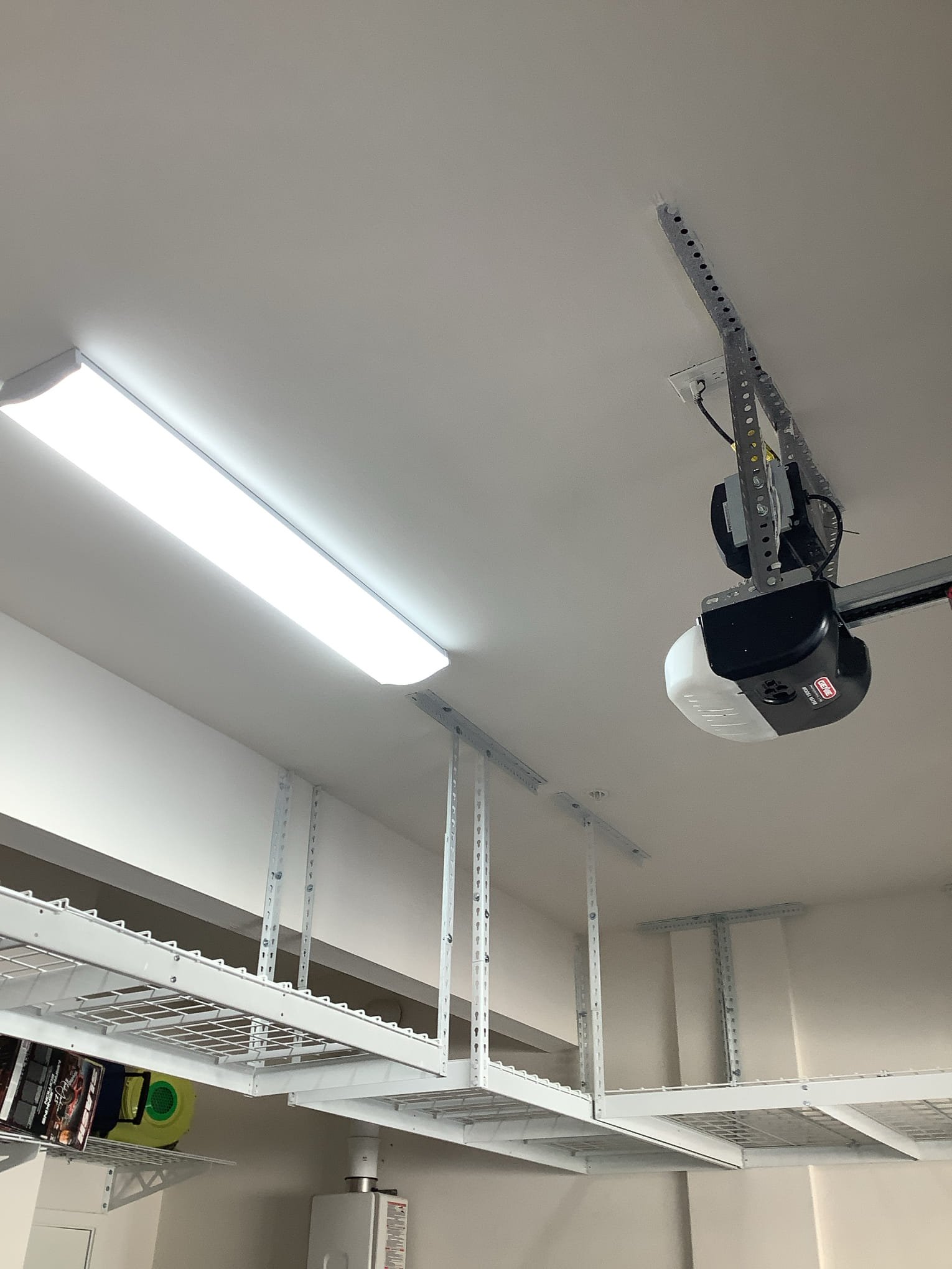 Powell Electric installed a tidy, reliable garage opener and bright overhead lighting to improve safety and usable storage space.