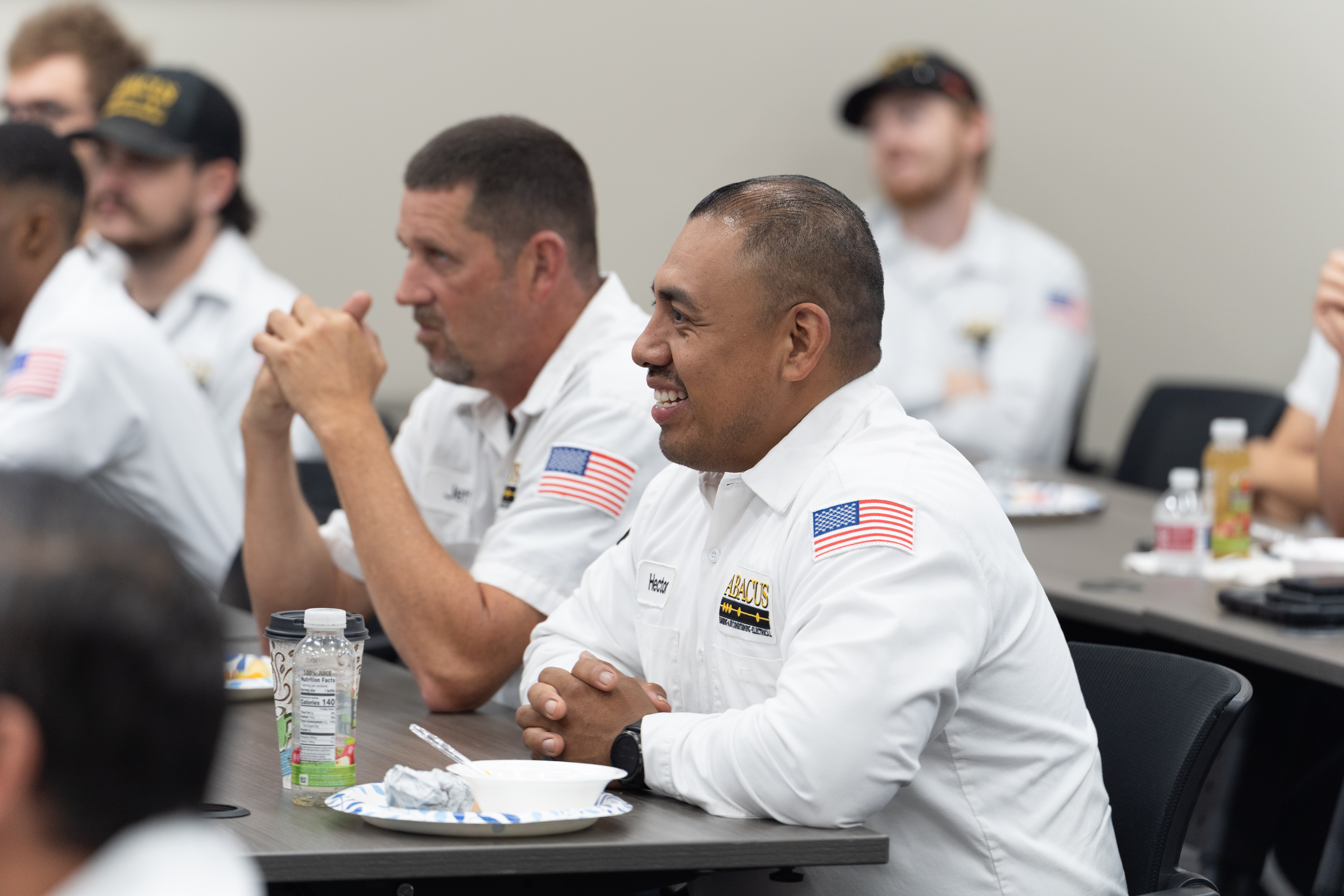 Team members gather for hands-on training, showing the dependable craftsmanship and commitment customers expect from Abacus Plumbing, Air Conditioning, & Electrical.