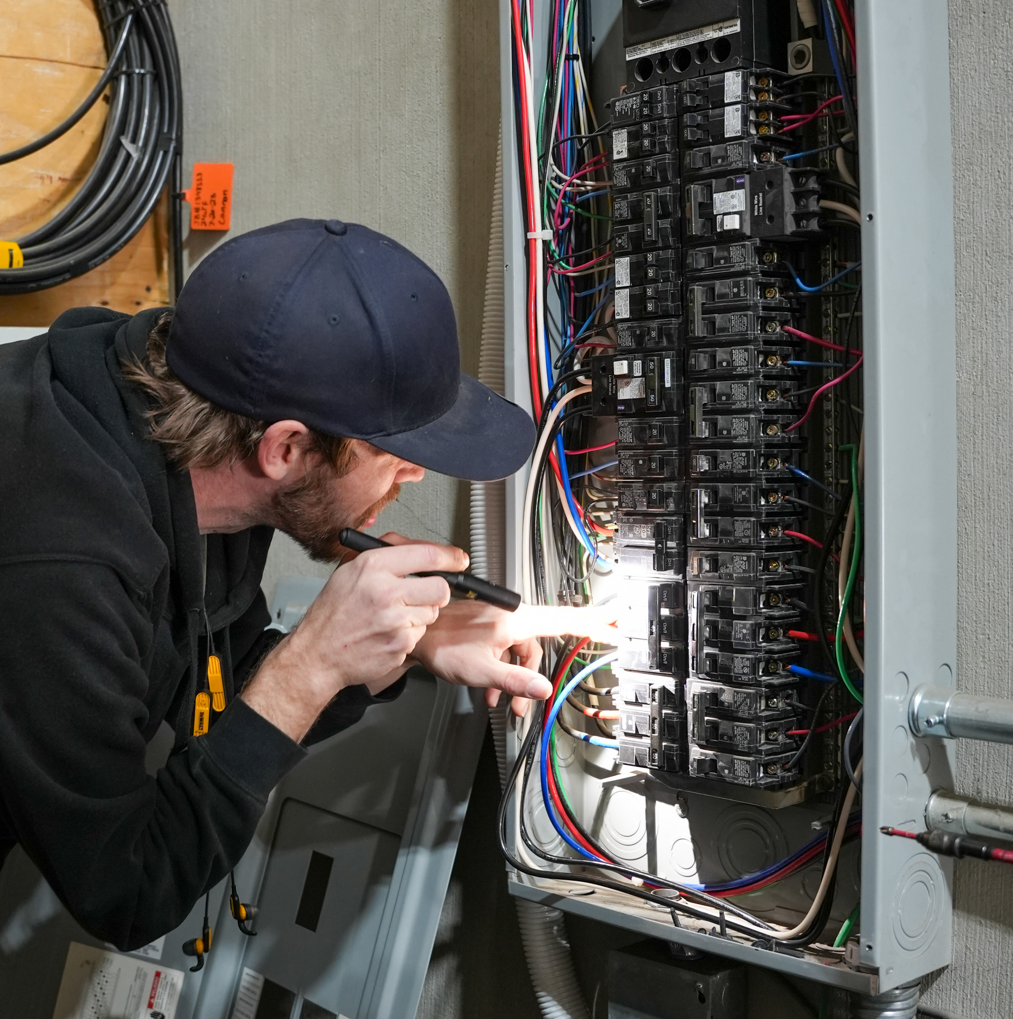 Skilled technicians from Eco Electric, Plumbing, Heating and Air carefully inspect electrical panels to ensure safe, reliable power for your home.