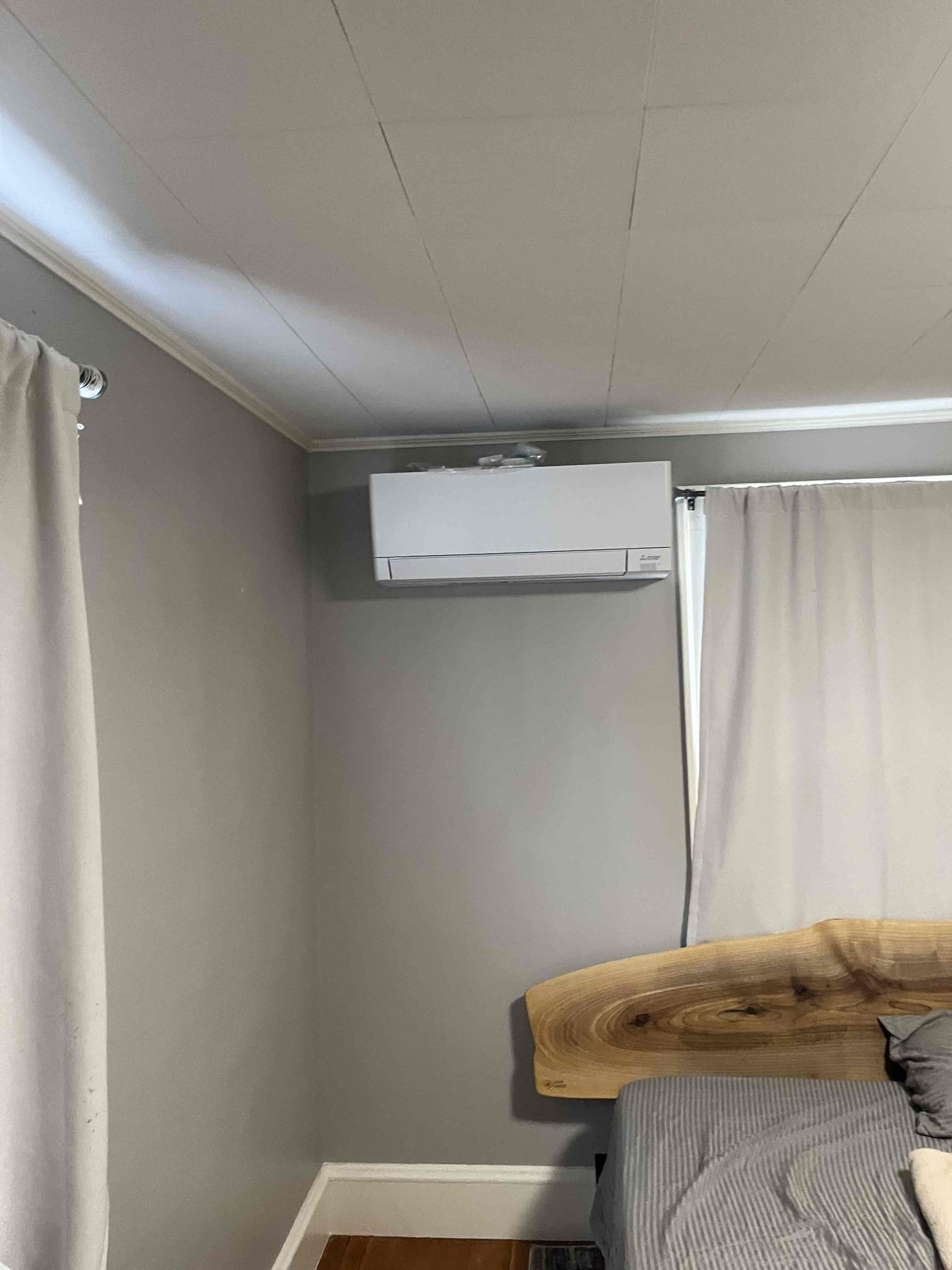 A clean residential ductless mini-split installation shows Akian Plumbing, Heating, Cooling & Electric delivering tidy, professional HVAC workmanship and comfort.