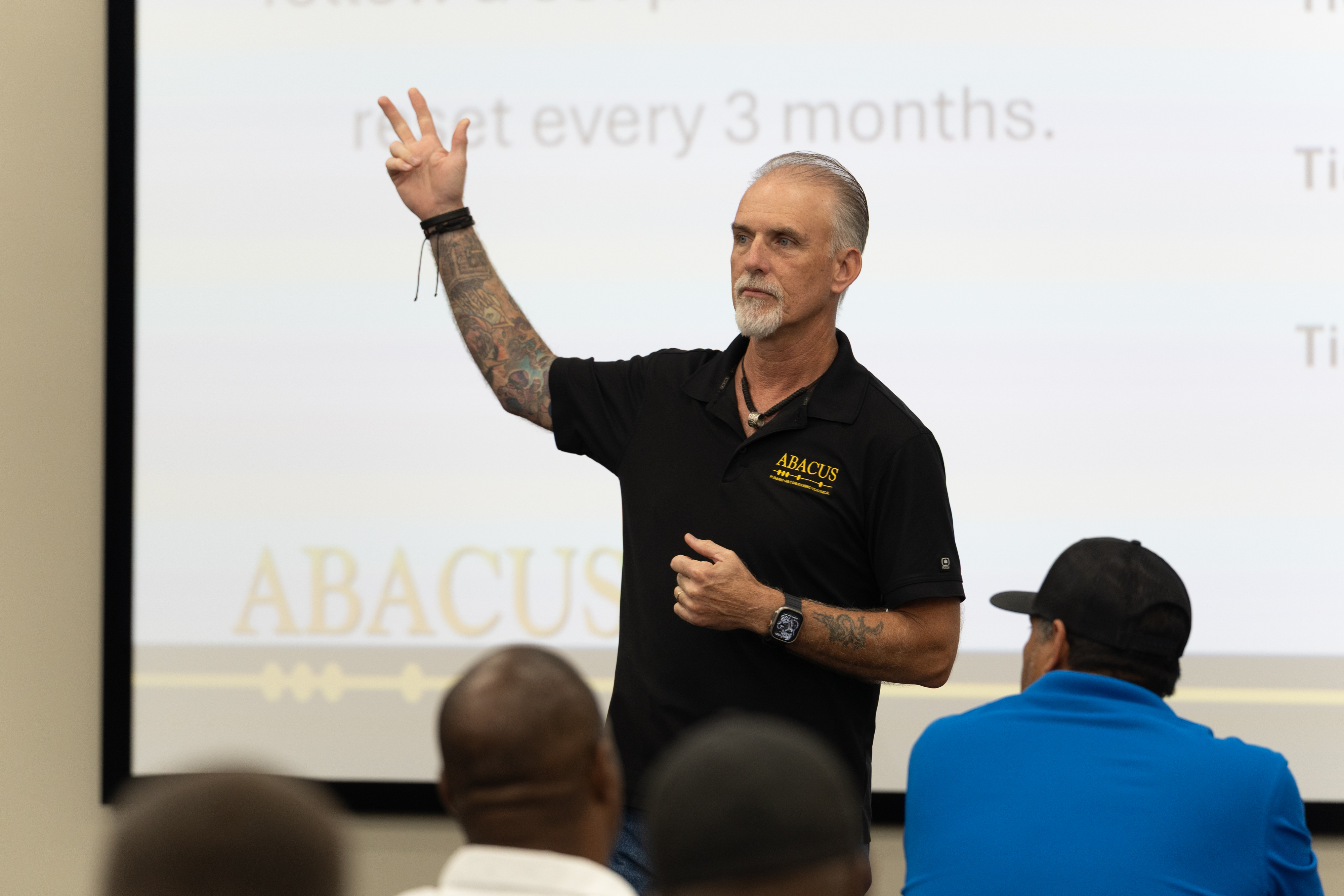 Team members learn best practices in a focused training session led by Abacus Plumbing, Air Conditioning, & Electrical to ensure reliable service.