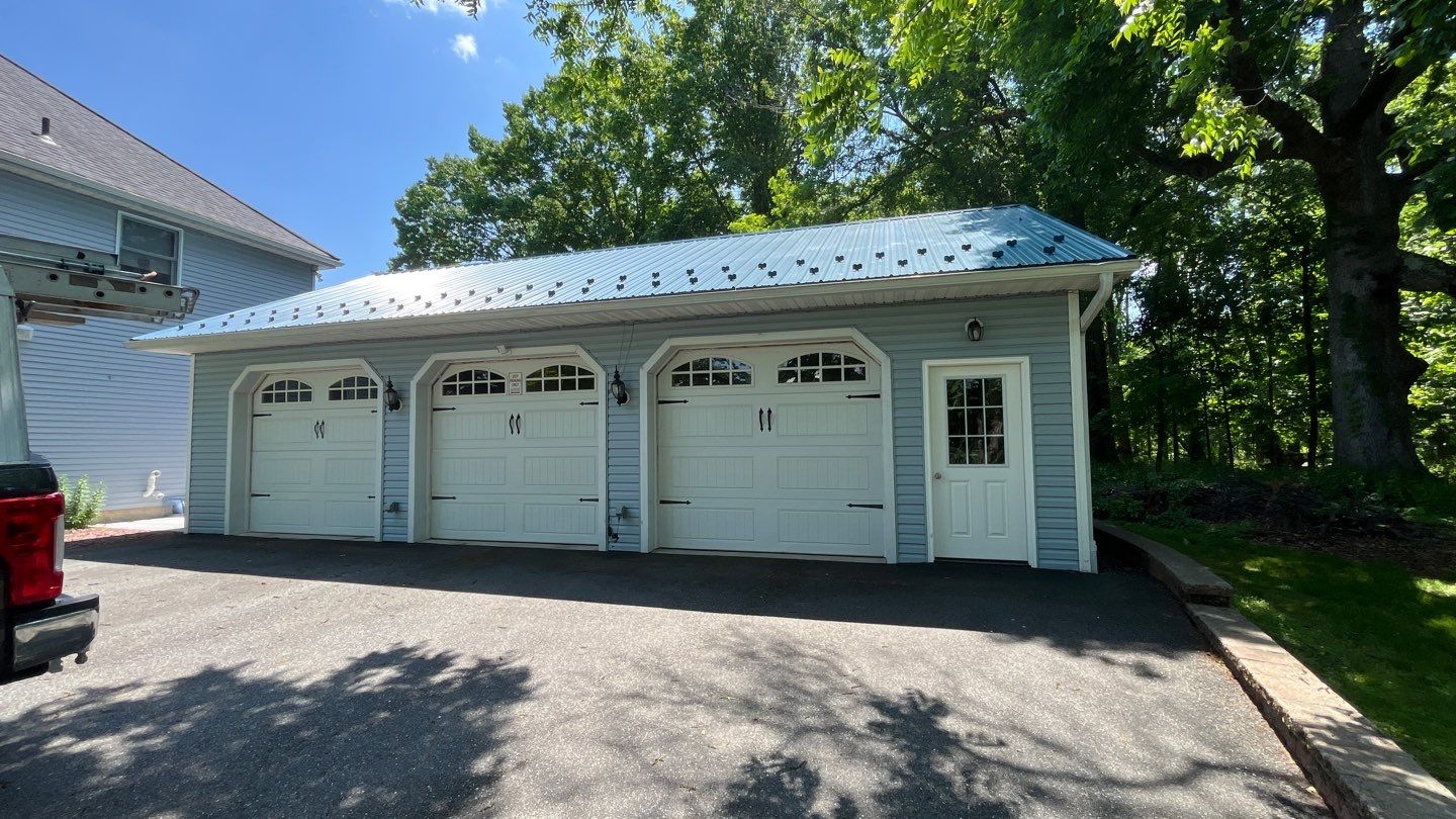 A durable metal roof and precise exterior finishes showcase Mast Roofing & Construction's commitment to lasting, high-quality craftsmanship.
