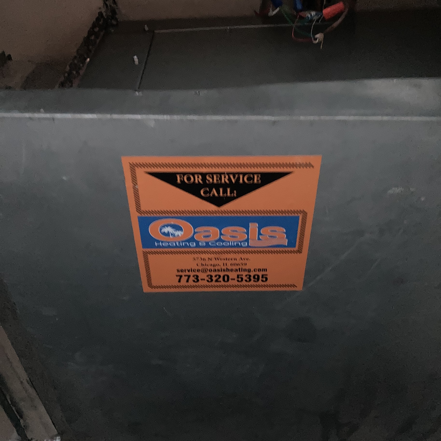 A visible service sticker on the unit highlights Oasis Heating and Cooling's reliable, professional care and easy customer contact.