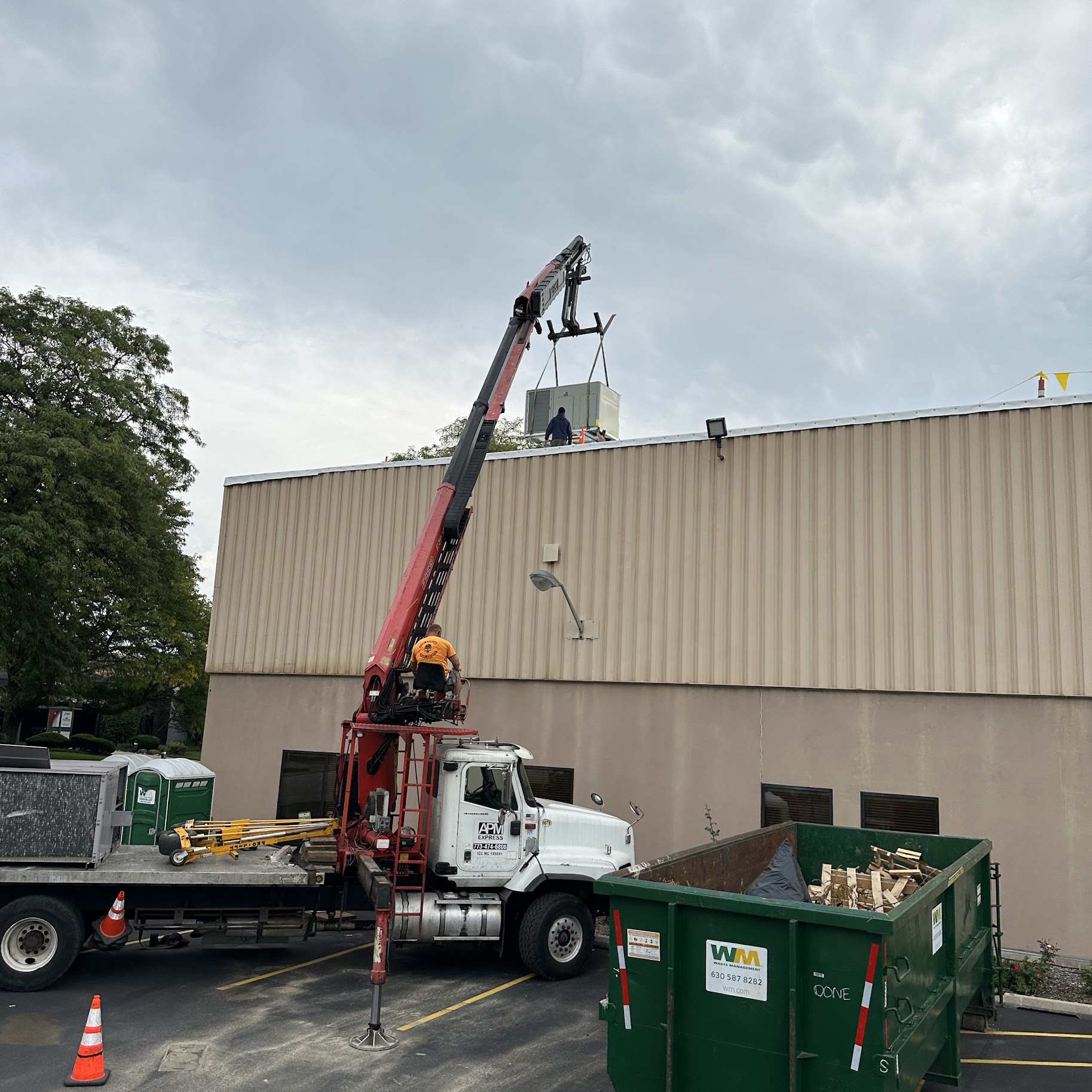 Skilled technicians from Oasis Heating and Cooling carefully set a rooftop unit in place, showcasing reliable, safety-focused service.