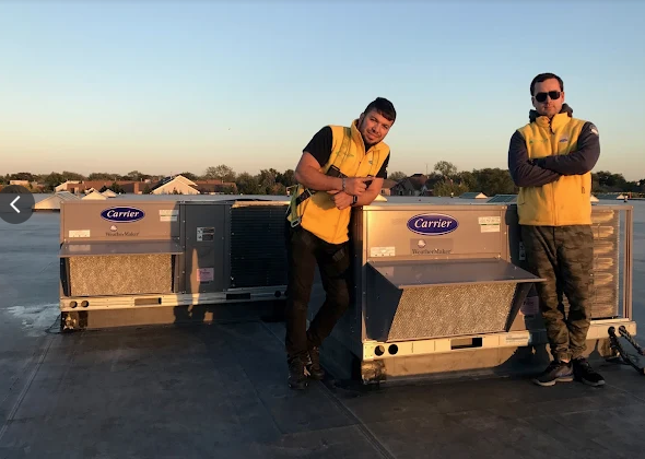 Green Air Care experts ensuring top-notch HVAC solutions with premium Carrier units under the evening sky.