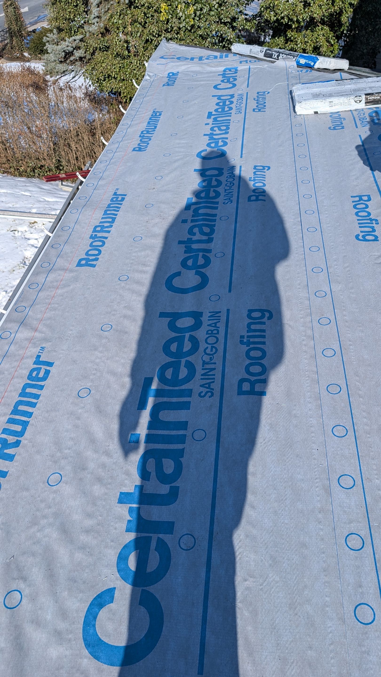 Confident craftsmanship on a winter roof replacement shows Mosaic Roofing & Exteriors using quality materials to protect your home.